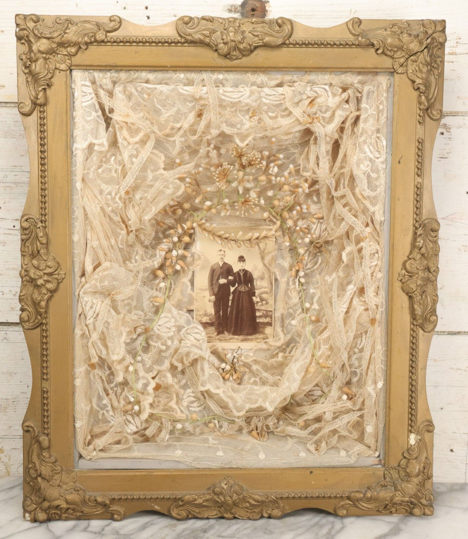 Lot 009 - Antique Victorian Wedding Commemoration Shadow Box With Lace Wedding Veil, Faux Floral Adornments, Cabinet Card Photograph Of Couple At Center, In Gesso Frame, 20-1/2" x 24-1/2" x 3-3/4"