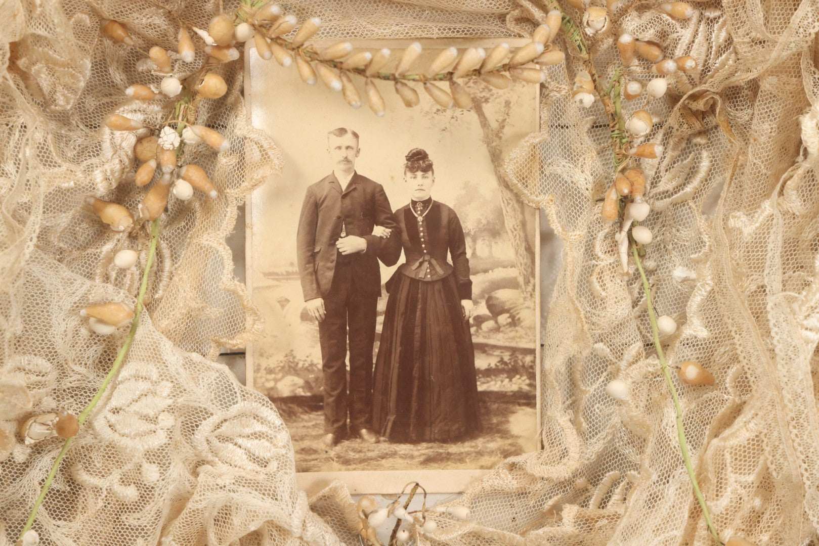 Lot 009 - Antique Victorian Wedding Commemoration Shadow Box With Lace Wedding Veil, Faux Floral Adornments, Cabinet Card Photograph Of Couple At Center, In Gesso Frame, 20-1/2" x 24-1/2" x 3-3/4"