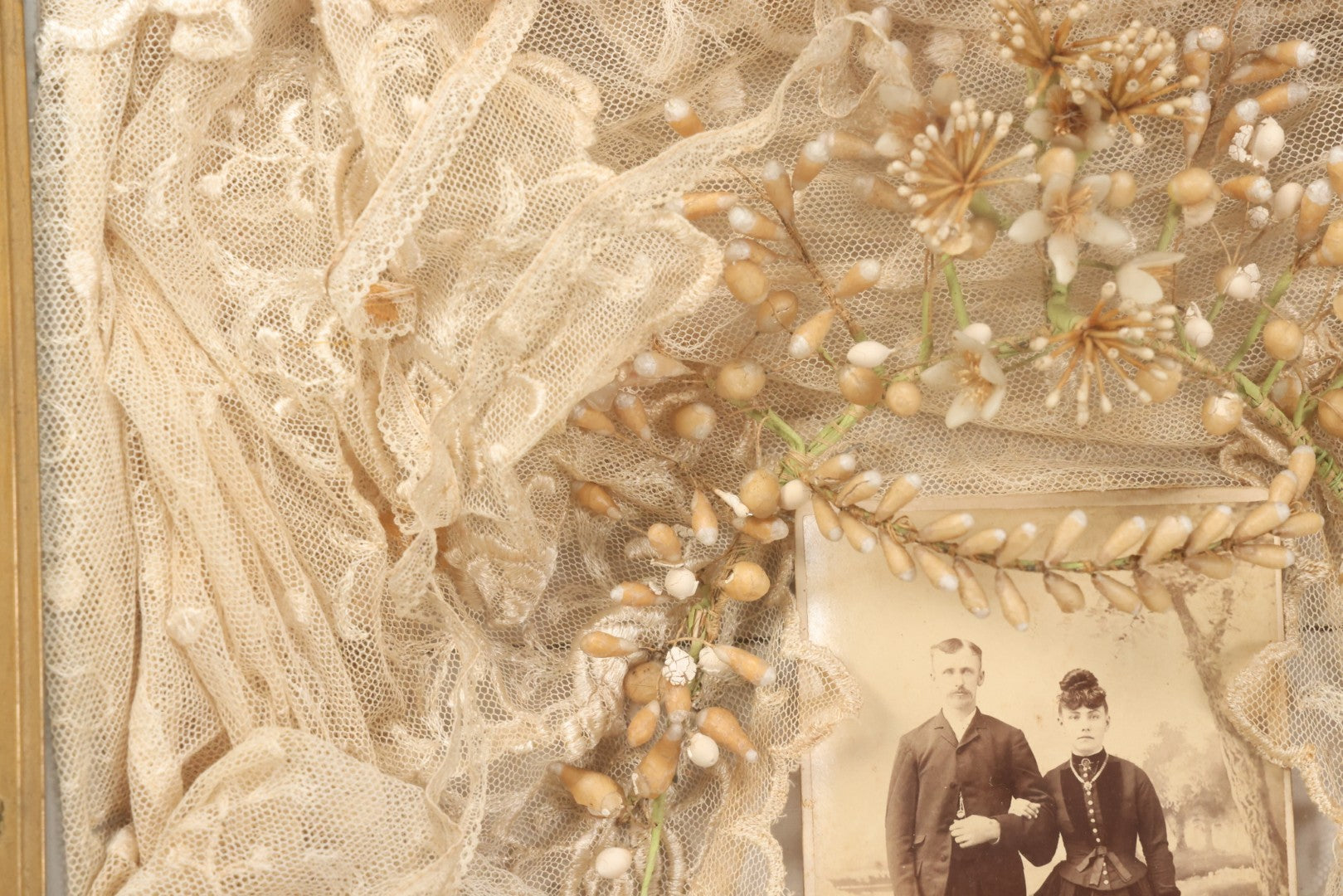 Lot 009 - Antique Victorian Wedding Commemoration Shadow Box With Lace Wedding Veil, Faux Floral Adornments, Cabinet Card Photograph Of Couple At Center, In Gesso Frame, 20-1/2" x 24-1/2" x 3-3/4"