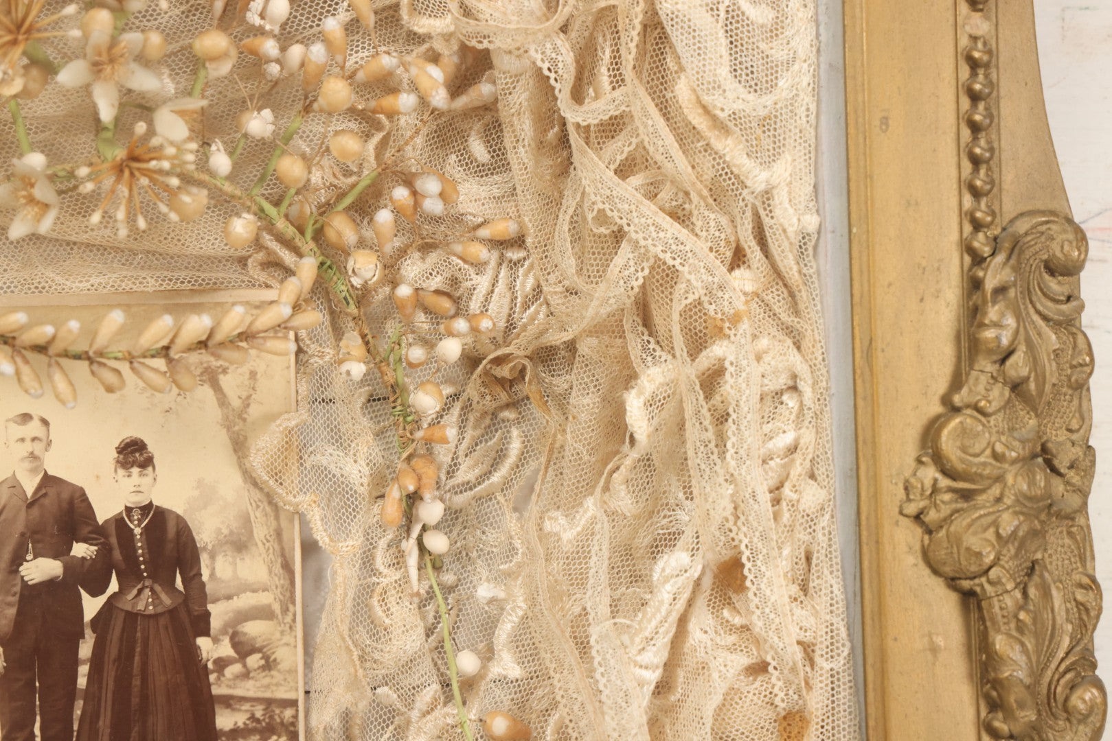 Lot 009 - Antique Victorian Wedding Commemoration Shadow Box With Lace Wedding Veil, Faux Floral Adornments, Cabinet Card Photograph Of Couple At Center, In Gesso Frame, 20-1/2" x 24-1/2" x 3-3/4"