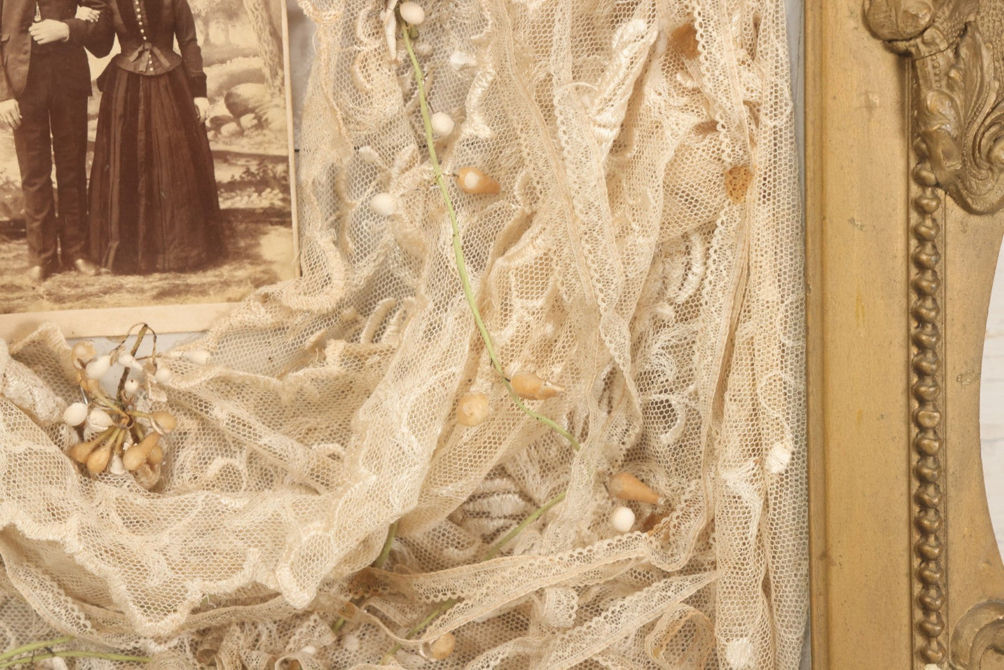 Lot 009 - Antique Victorian Wedding Commemoration Shadow Box With Lace Wedding Veil, Faux Floral Adornments, Cabinet Card Photograph Of Couple At Center, In Gesso Frame, 20-1/2" x 24-1/2" x 3-3/4"