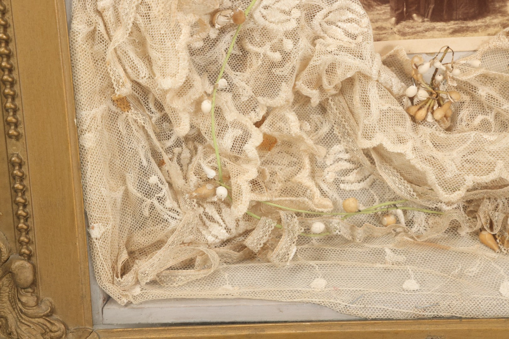 Lot 009 - Antique Victorian Wedding Commemoration Shadow Box With Lace Wedding Veil, Faux Floral Adornments, Cabinet Card Photograph Of Couple At Center, In Gesso Frame, 20-1/2" x 24-1/2" x 3-3/4"