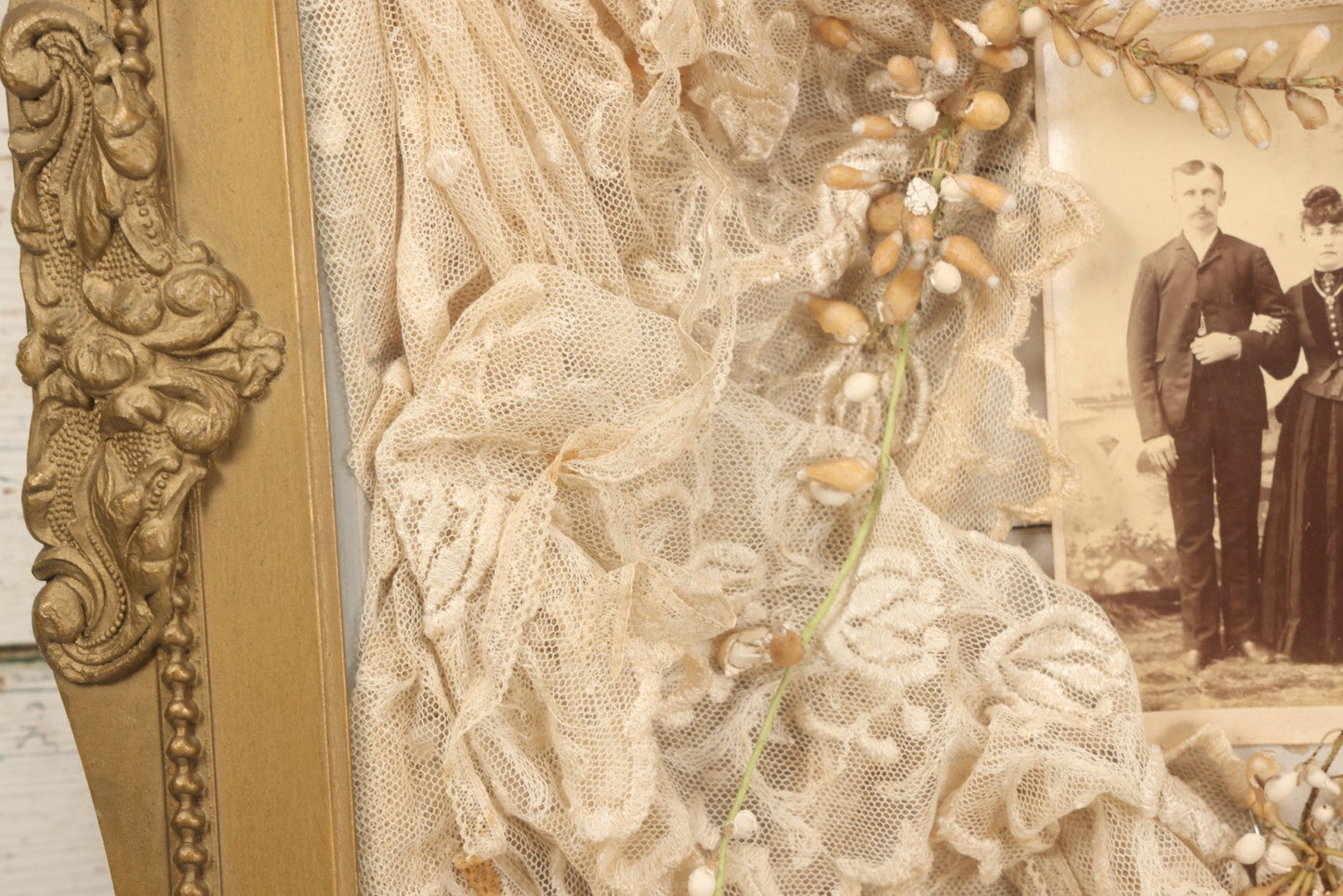 Lot 009 - Antique Victorian Wedding Commemoration Shadow Box With Lace Wedding Veil, Faux Floral Adornments, Cabinet Card Photograph Of Couple At Center, In Gesso Frame, 20-1/2" x 24-1/2" x 3-3/4"