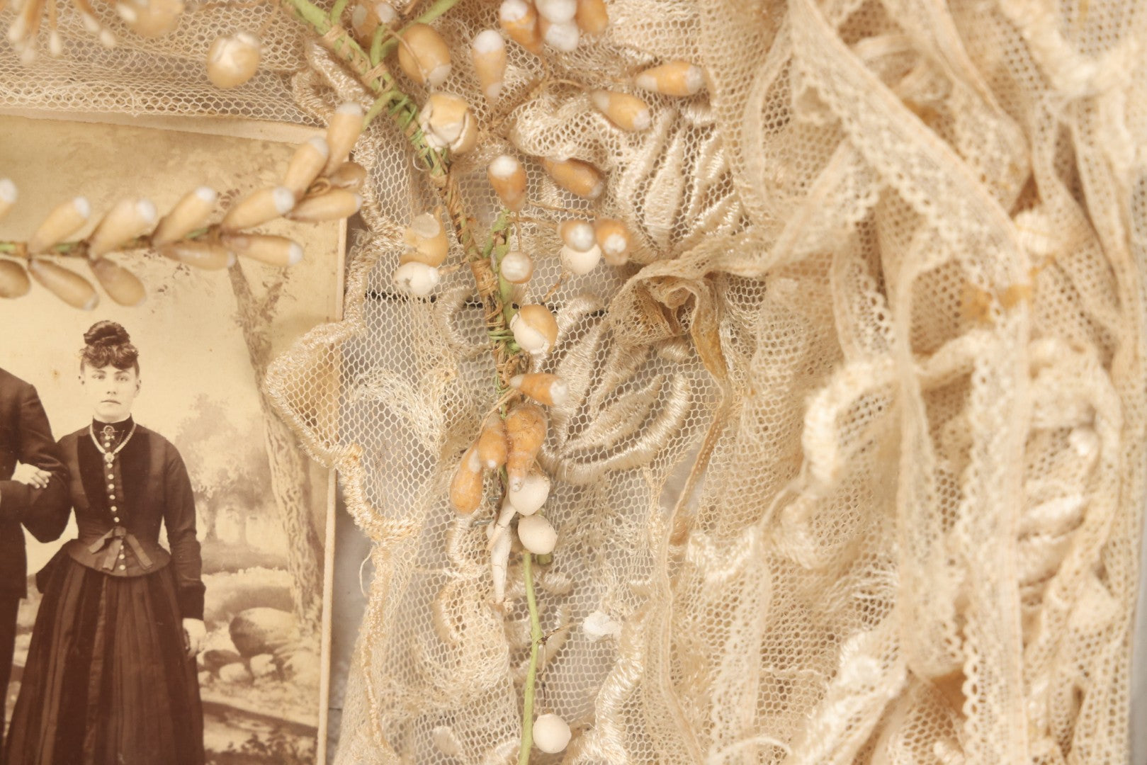 Lot 009 - Antique Victorian Wedding Commemoration Shadow Box With Lace Wedding Veil, Faux Floral Adornments, Cabinet Card Photograph Of Couple At Center, In Gesso Frame, 20-1/2" x 24-1/2" x 3-3/4"