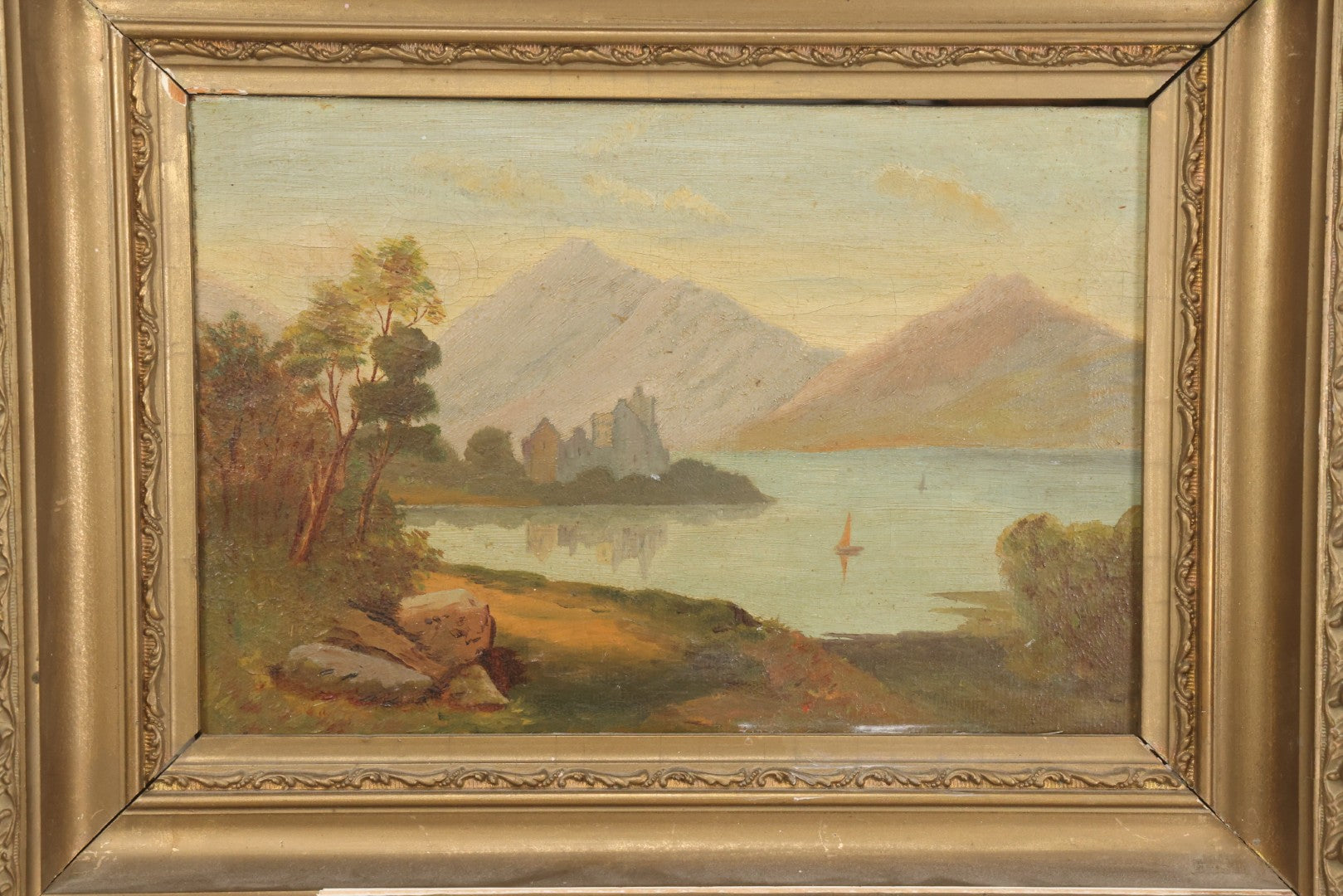 Lot 014 - Antique Oil On Canvas Painting Of A Mountainside Lake Scene With Sailboats, Building At Foot Of Mountain, Likely European, Unsigned, Circa  Mid 19th Century, 17" x 13"