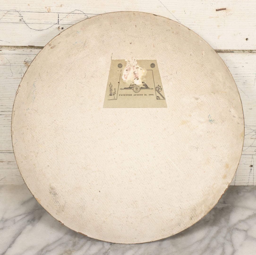 Lot 016 - Antique Painting On Composition Charger, Nautical Scene Seaside Town, Sailboat On Shore, 12" Diameter, Paper Label On Verso, Circa 1880s, Note Pinhole At Center, Missing Hanging Hook On Verso