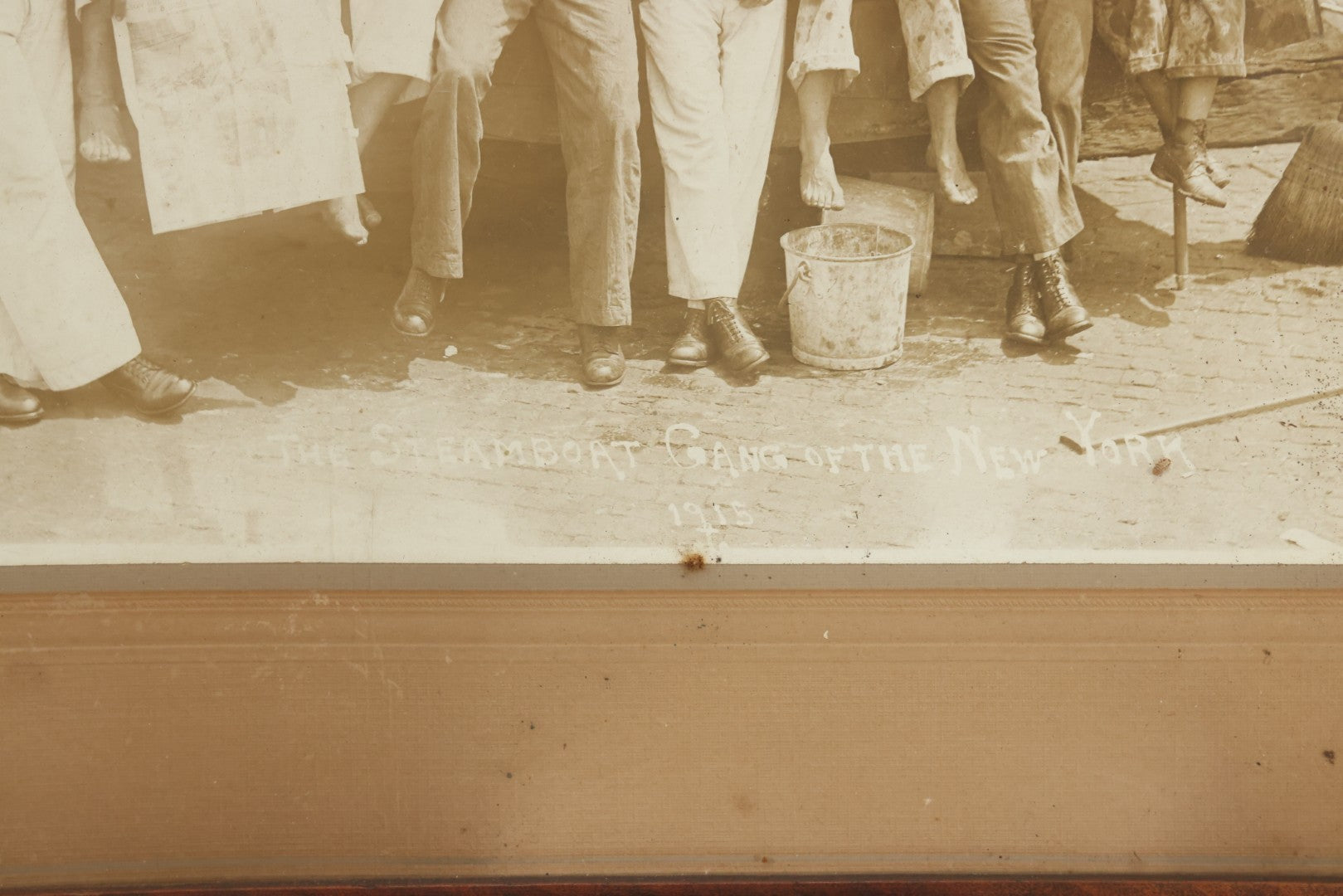 Lot 019 - Antique Boarded Photograph In Frame Of "The Steamboat Gang Of The New York," 1915, Occupational Photos Of Navy Sailors On Dock, With Tools Of The Trade, Other Workers In Background, U.S.S. New York (BB-34), 15-1/2" x 13-1/2"
