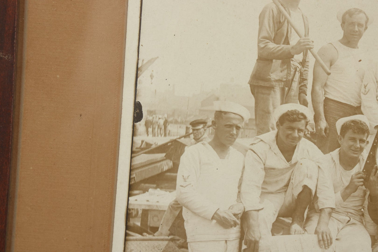 Lot 019 - Antique Boarded Photograph In Frame Of "The Steamboat Gang Of The New York," 1915, Occupational Photos Of Navy Sailors On Dock, With Tools Of The Trade, Other Workers In Background, U.S.S. New York (BB-34), 15-1/2" x 13-1/2"