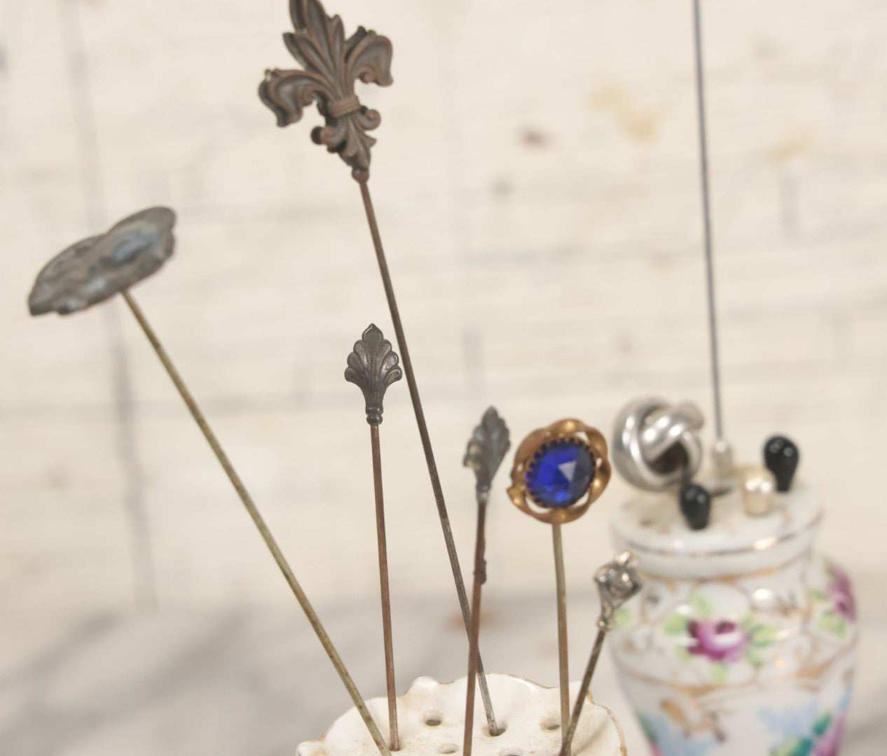 Lot 040 - Grouping Of Twelve Antique Hat Pins And Two Porcelain Hat Pin Holders, Including Some With Sterling, Blue Gem, Art Nouveau, And More