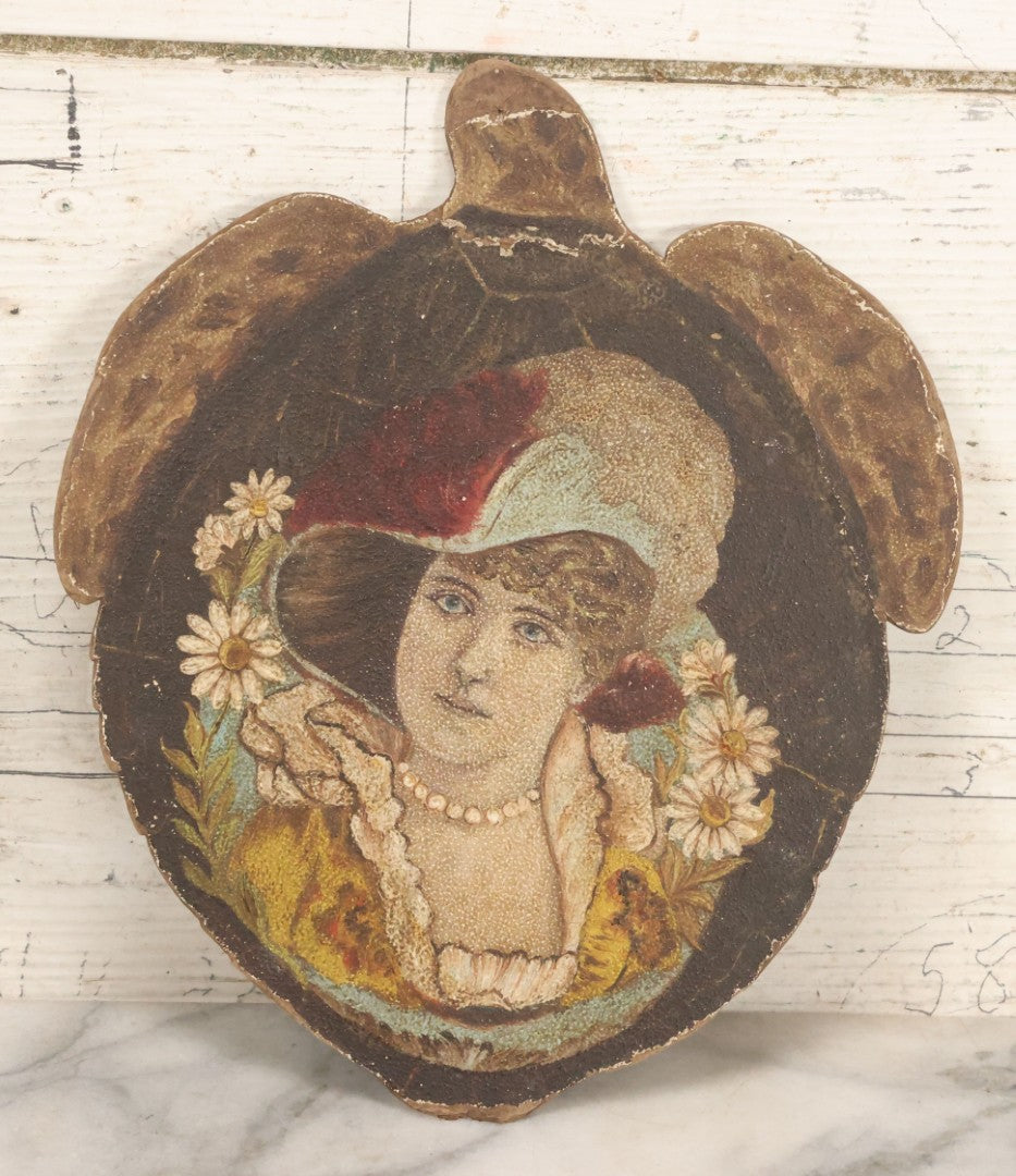 Lot 048 - Antique Hand Painted Die Cut Turtle Painting Board With Image Of A Woman In A Hat Surrounded By Daisies, Note Wear To Turtle's Neck