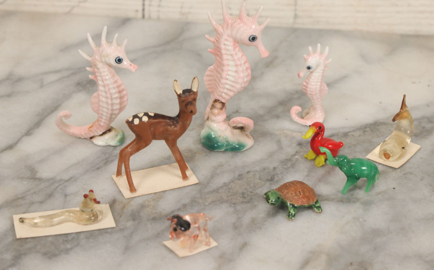 Lot 072 - Miscellaneous Box Lot Grouping Of Glass And Porcelain Animals Including Seahorses, Small Glass Creatures, Plastic Deer, And More, As Found In The Box It Was Found In, Not All Pictured