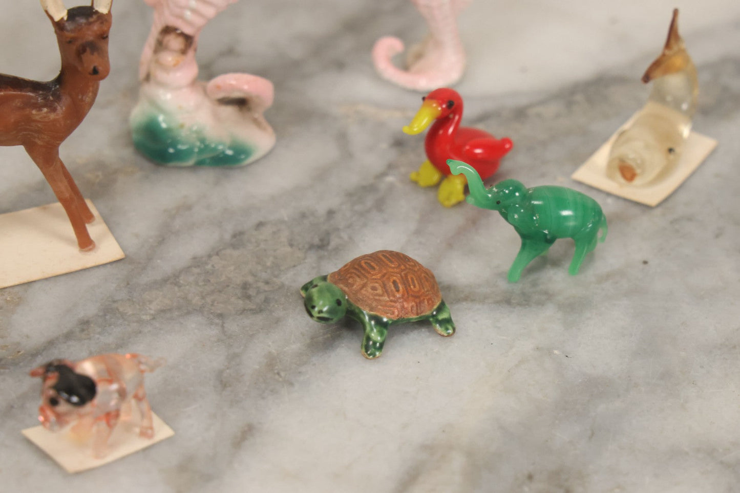 Lot 072 - Miscellaneous Box Lot Grouping Of Glass And Porcelain Animals Including Seahorses, Small Glass Creatures, Plastic Deer, And More, As Found In The Box It Was Found In, Not All Pictured