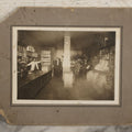 Lot 080 - Antique Boarded Occupational Photograph Of The Interior Of A General Store With Four Men In Frame, Many Products, Advertisements, Note Corner Losses