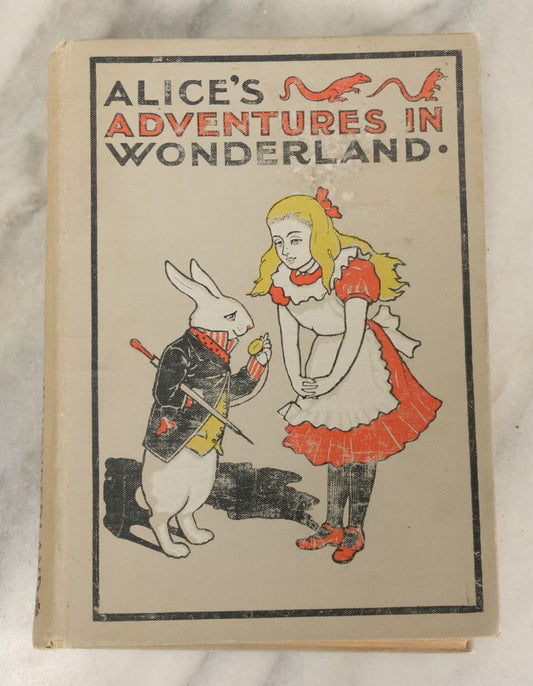 Lot 139 - "Alice's Adventures In Wonderland" Vintage Book By Lewis Carroll With 40 Illustrations By John Tenniel, W.B. Conkey, Publishers, Chicago, Early 20th Century, With Illustrated Cover, Note Slight Warping To Covers