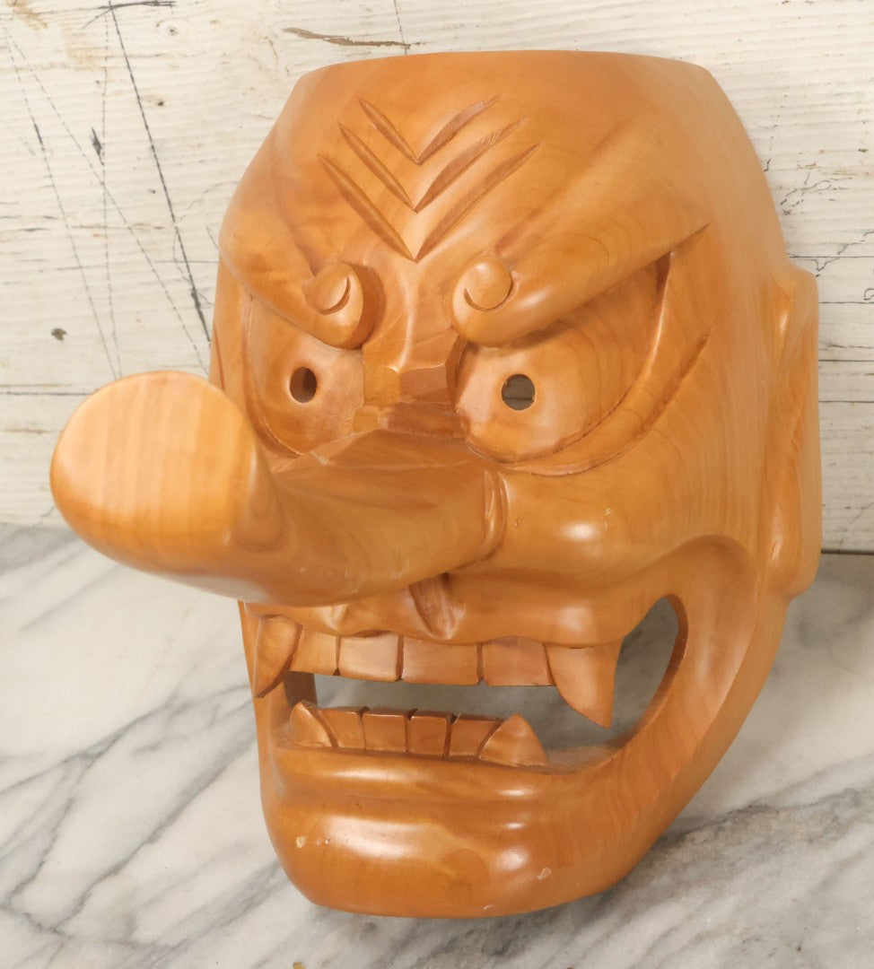 Lot 011 - Contemporary Japanese Hannya Mask With Comically Large Nose, Hand Carved Wood, Unpainted, With Rope Hanger