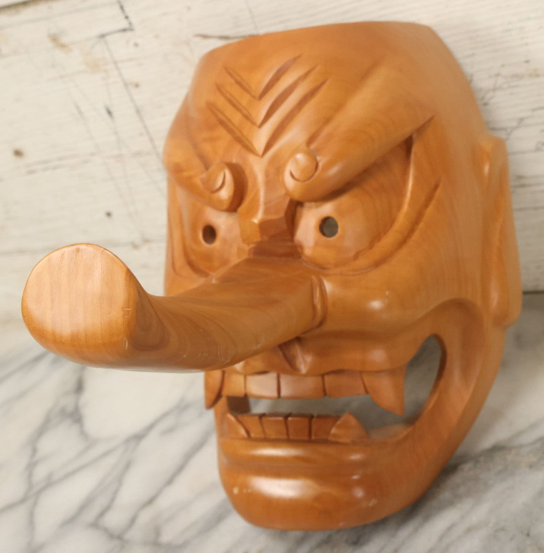 Lot 011 - Contemporary Japanese Hannya Mask With Comically Large Nose, Hand Carved Wood, Unpainted, With Rope Hanger