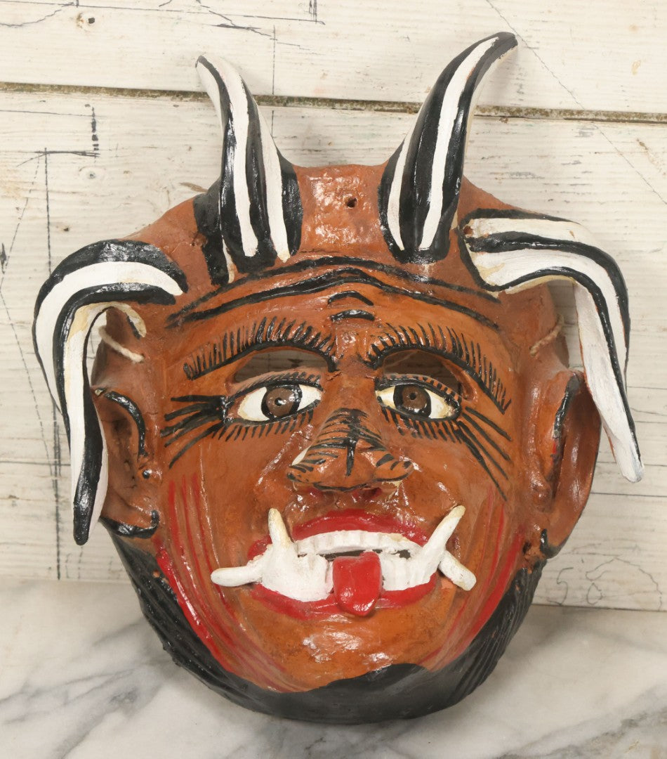 Lot 013 - Vintage Clay Devil Demon Mask With Curly Black And White Horns, Fangs, And Forked Nose, Hand Sculpted, Hand Painted, With Rope Hanger