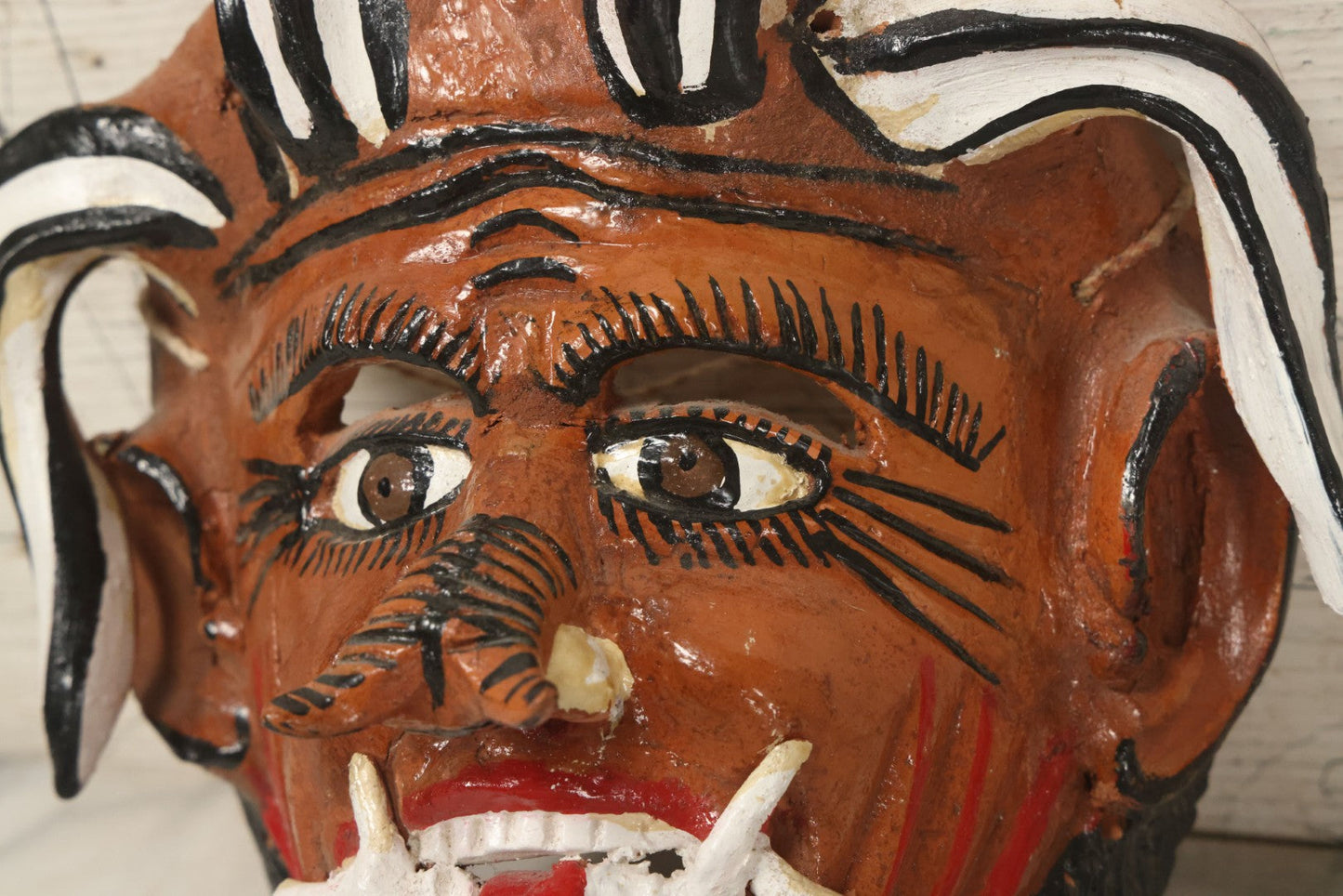 Lot 013 - Vintage Clay Devil Demon Mask With Curly Black And White Horns, Fangs, And Forked Nose, Hand Sculpted, Hand Painted, With Rope Hanger