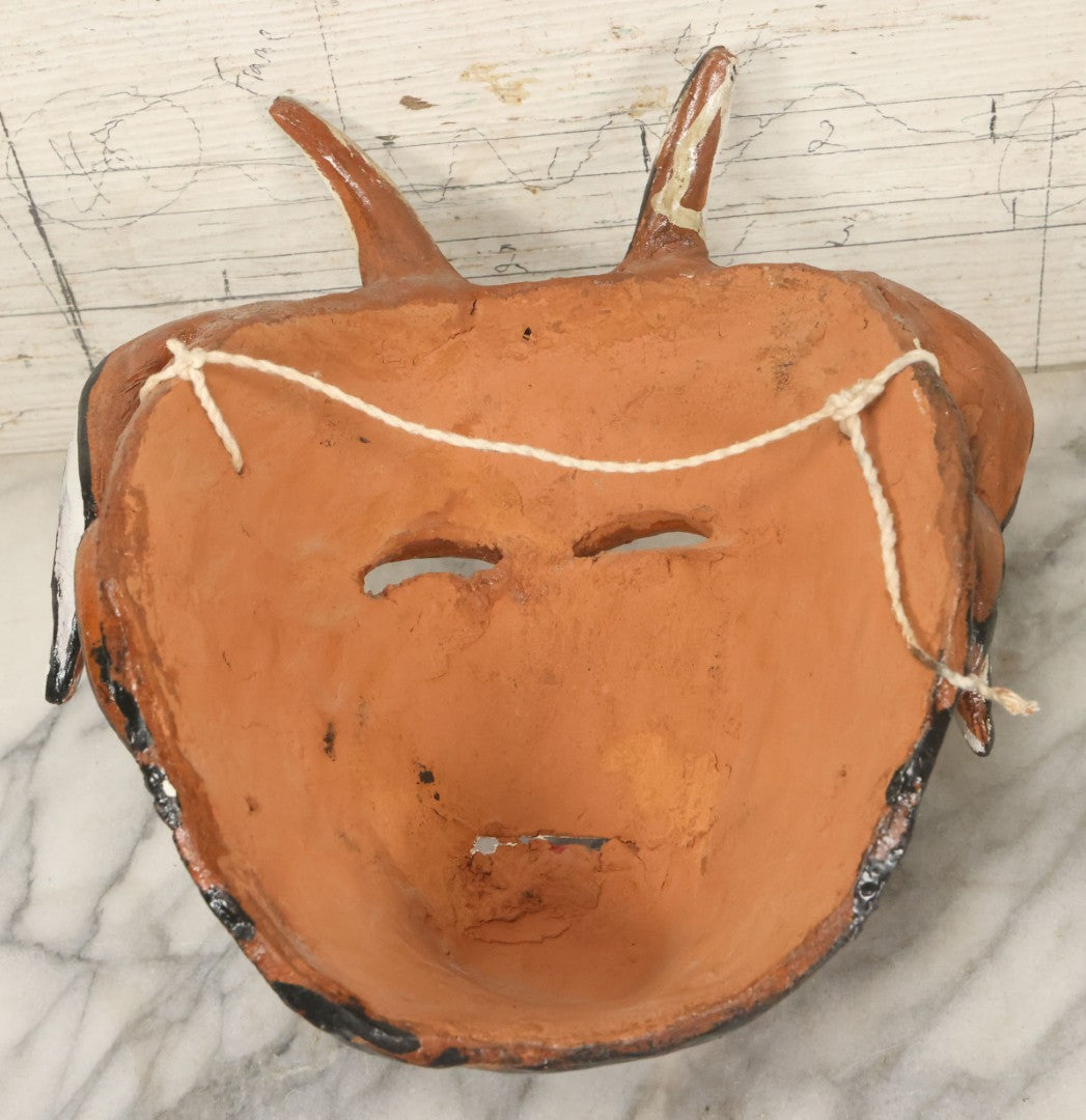 Lot 013 - Vintage Clay Devil Demon Mask With Curly Black And White Horns, Fangs, And Forked Nose, Hand Sculpted, Hand Painted, With Rope Hanger