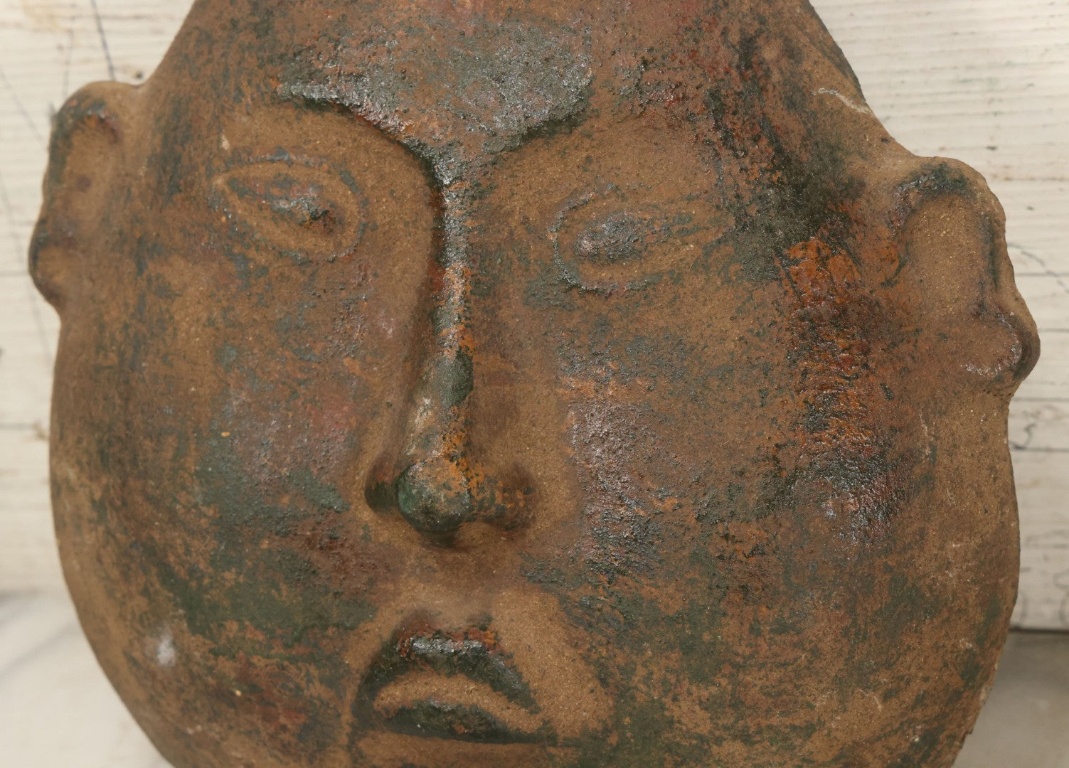 Lot 015 - Vintage Green Clay Eastern Mask With Rotund Face, Sad Expression, Faux-Patina Finish, With Wire Hanger