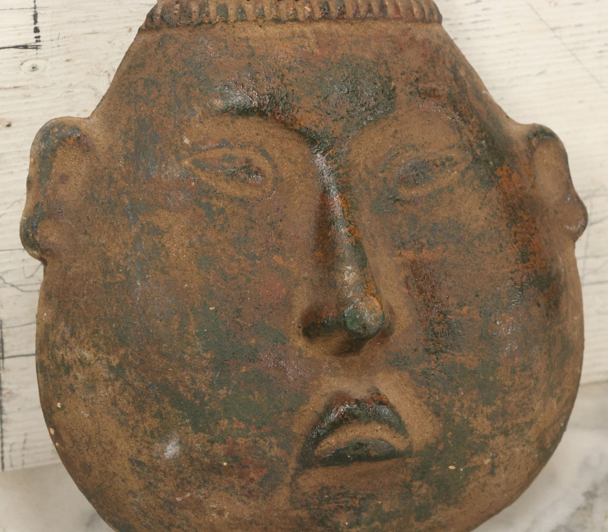 Lot 015 - Vintage Green Clay Eastern Mask With Rotund Face, Sad Expression, Faux-Patina Finish, With Wire Hanger