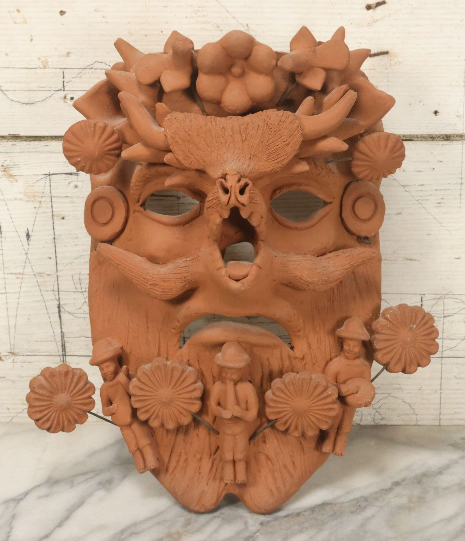 Lot 016 - Vintage Unpainted Red Clay Mexican Folk Art Mask, Made In Mexico Sticker On Verso, With Posable Wire Attached Adornments, With Wire Hanger