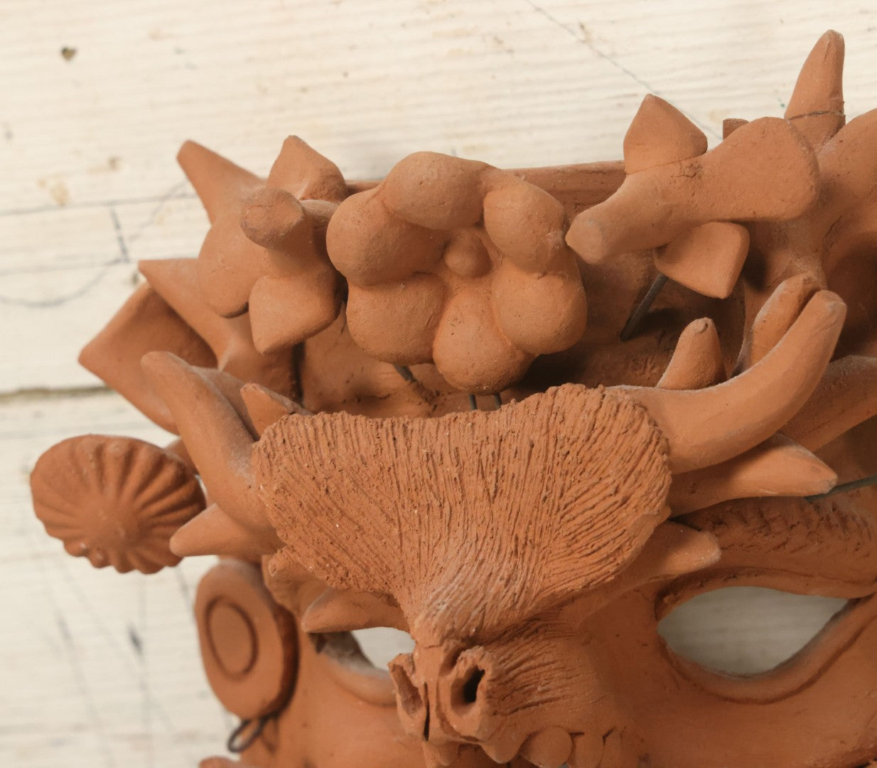 Lot 016 - Vintage Unpainted Red Clay Mexican Folk Art Mask, Made In Mexico Sticker On Verso, With Posable Wire Attached Adornments, With Wire Hanger