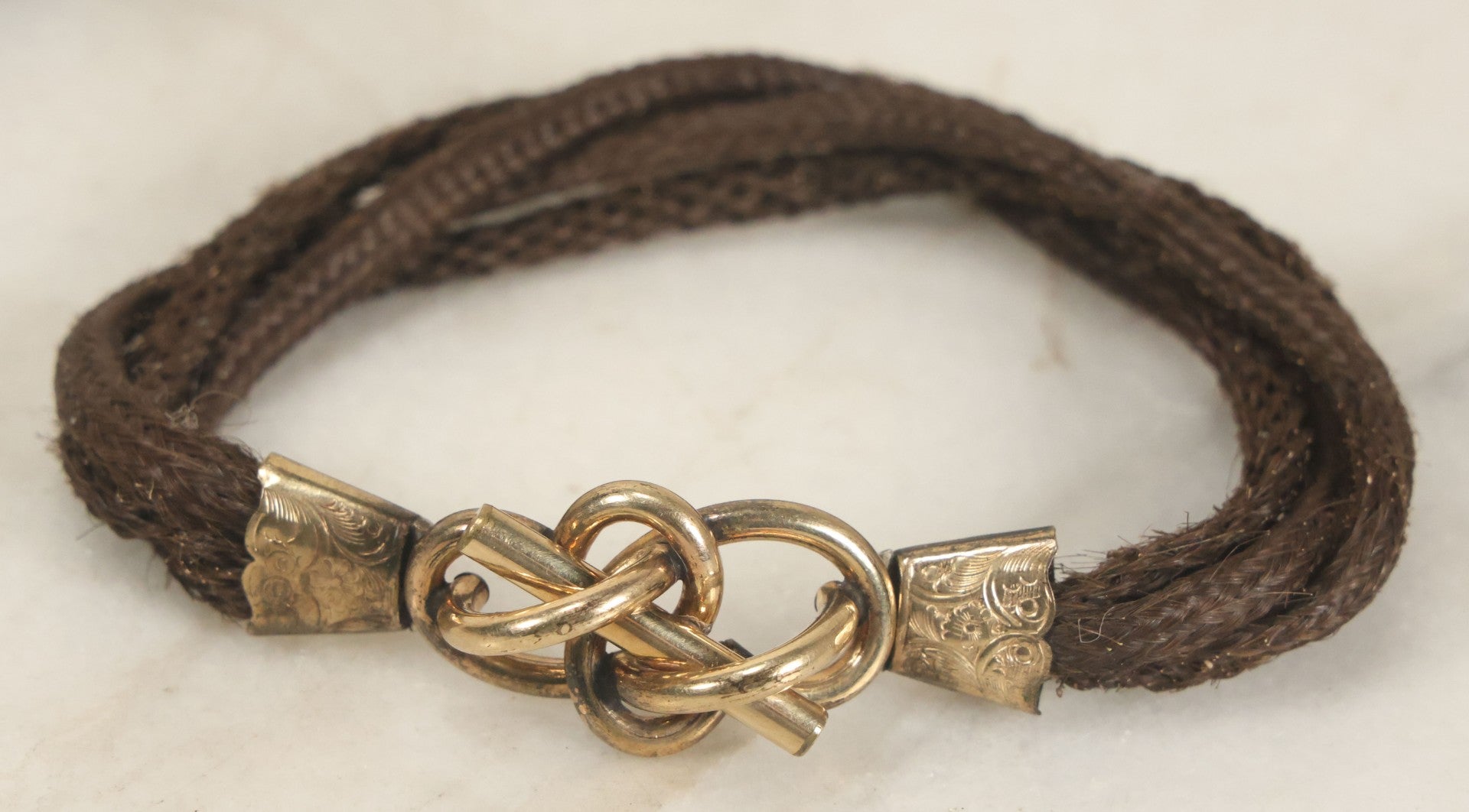 Lot 020 - Antique Victorian Human Hair Work Cuff Bracelet With Brass Adornments, Opening Diameter Approximately 2-3/4"