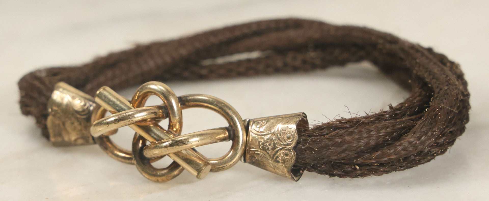 Lot 020 - Antique Victorian Human Hair Work Cuff Bracelet With Brass Adornments, Opening Diameter Approximately 2-3/4"