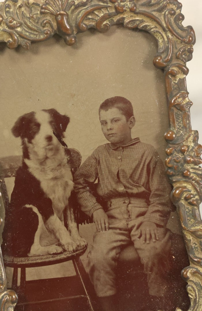 Lot 023 - Antique Tintype Photograph Of Young Boy And Border Collie Dog Seated On Chair, In Period Pressed Brass Ormolu Frame With Kickstand