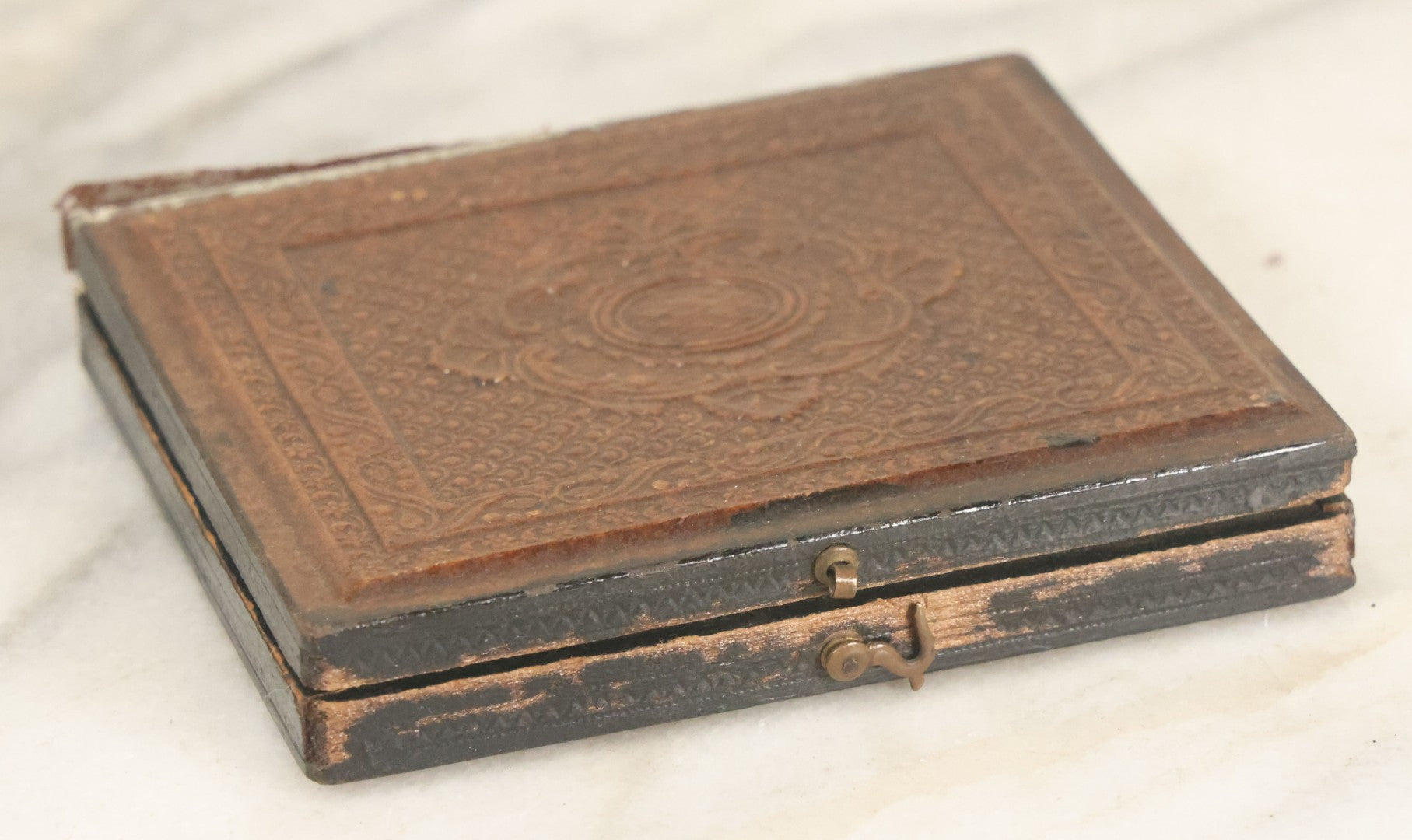 Lot 027 - Antique 1/6th Plate Ambrotype Photograph Of Young Mother Holding Newborn Baby, Wearing Tinted Jewelry, In Full Leatherette Union Case, Note Spine Repaired With Tape