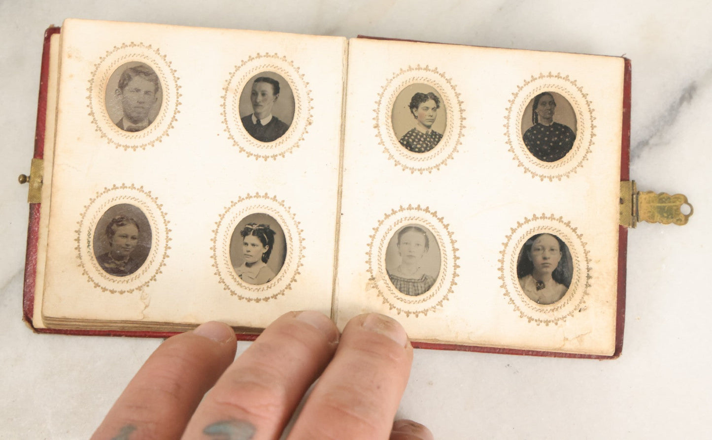 Lot 028 - Antique Red Covered Gem Tintype Photo Album, With 64 Gem Tintype Photographs Including Man In Fur Hat, Man In Top Hat, And Many Women And Children (All Pages Pictured)