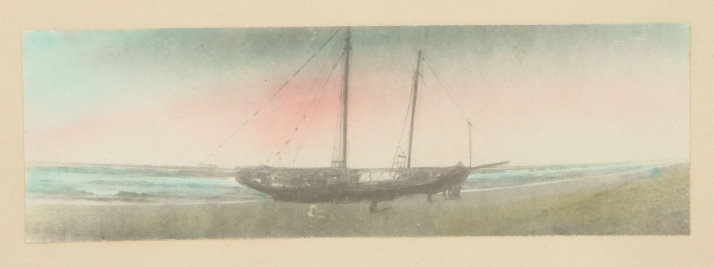 Lot 040 - Vintage Hand Tinted Photograph Of Sailboat Washed Up On Shore At Sunset, In Frame, 11" x 6-3/4"