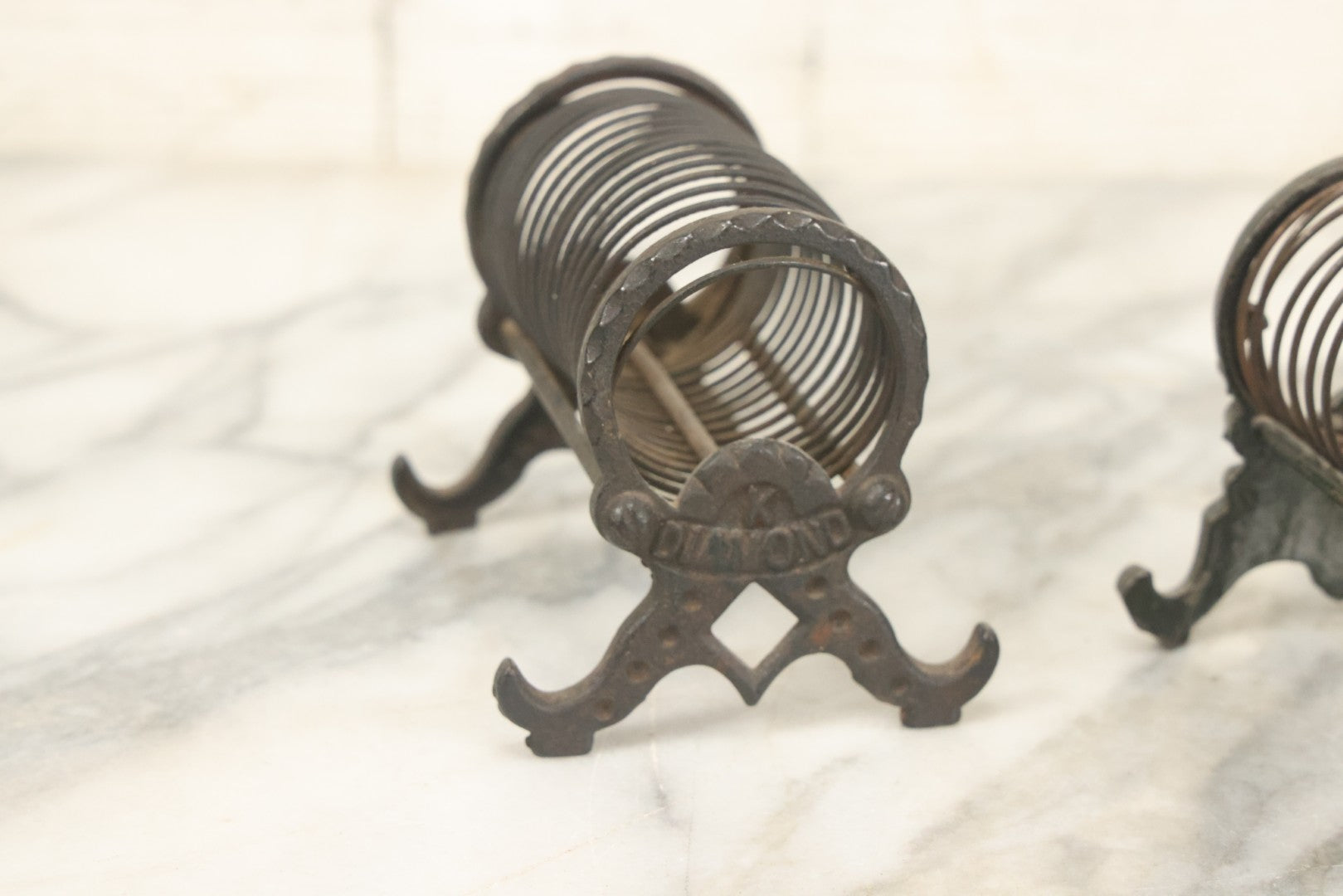 Lot 071 - Pair Of Vintage Cast Iron Spring Coil Letter Holders With Legs, Boots, One By K. Diamond, One By Mutat, No. 17 In Old Green Paint