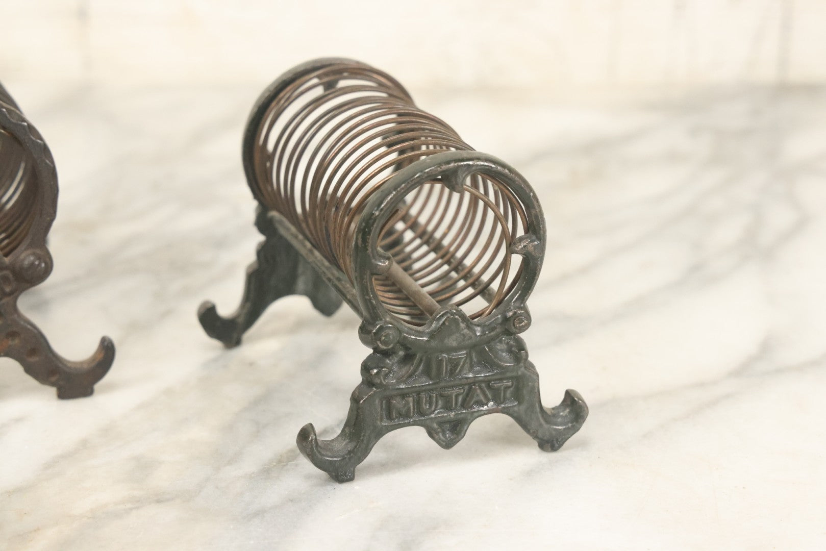 Lot 071 - Pair Of Vintage Cast Iron Spring Coil Letter Holders With Legs, Boots, One By K. Diamond, One By Mutat, No. 17 In Old Green Paint
