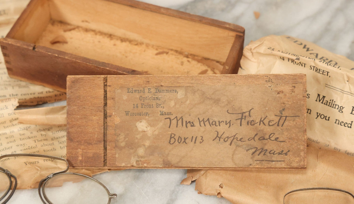 Lot 079 - Antique Slide Top Wooden Mailing Box From Edward E Dammers, Optician, Worcester, Massachusetts, Containing Two Pairs Of Antique Eyeglasses And Advertising Ephemera, Addressed To Mary Fickett, As Found, Note Cracks And Wear