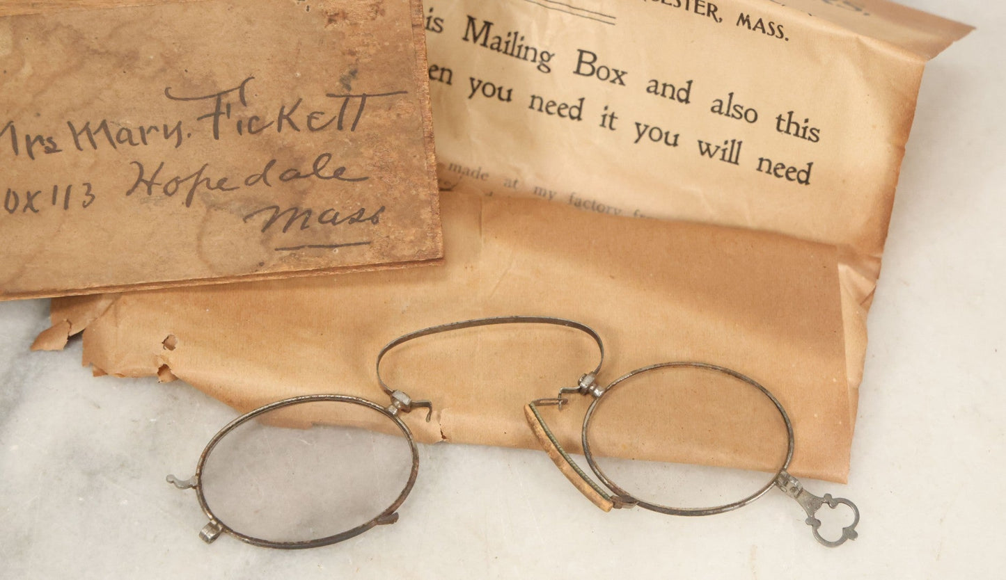 Lot 079 - Antique Slide Top Wooden Mailing Box From Edward E Dammers, Optician, Worcester, Massachusetts, Containing Two Pairs Of Antique Eyeglasses And Advertising Ephemera, Addressed To Mary Fickett, As Found, Note Cracks And Wear