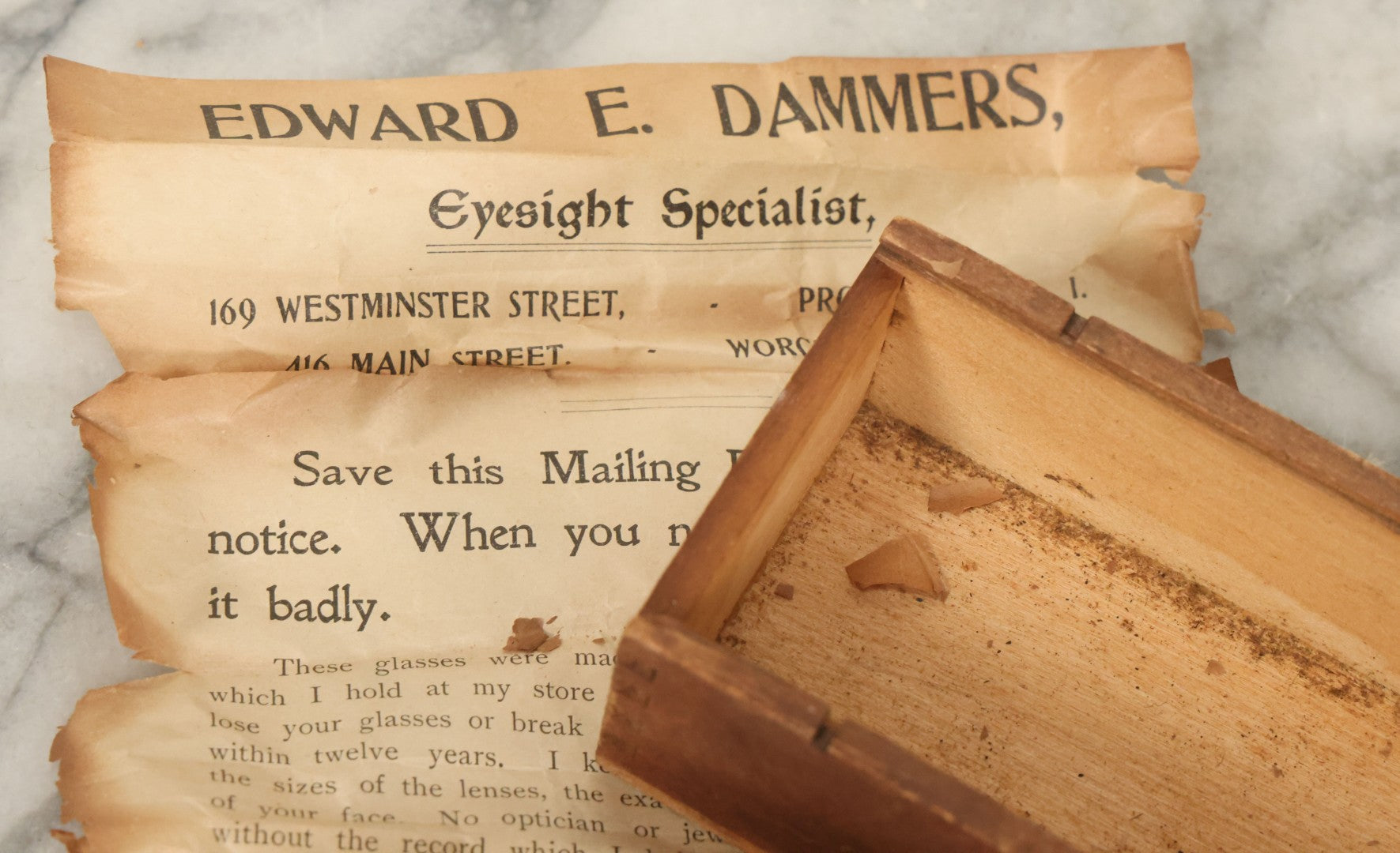 Lot 079 - Antique Slide Top Wooden Mailing Box From Edward E Dammers, Optician, Worcester, Massachusetts, Containing Two Pairs Of Antique Eyeglasses And Advertising Ephemera, Addressed To Mary Fickett, As Found, Note Cracks And Wear