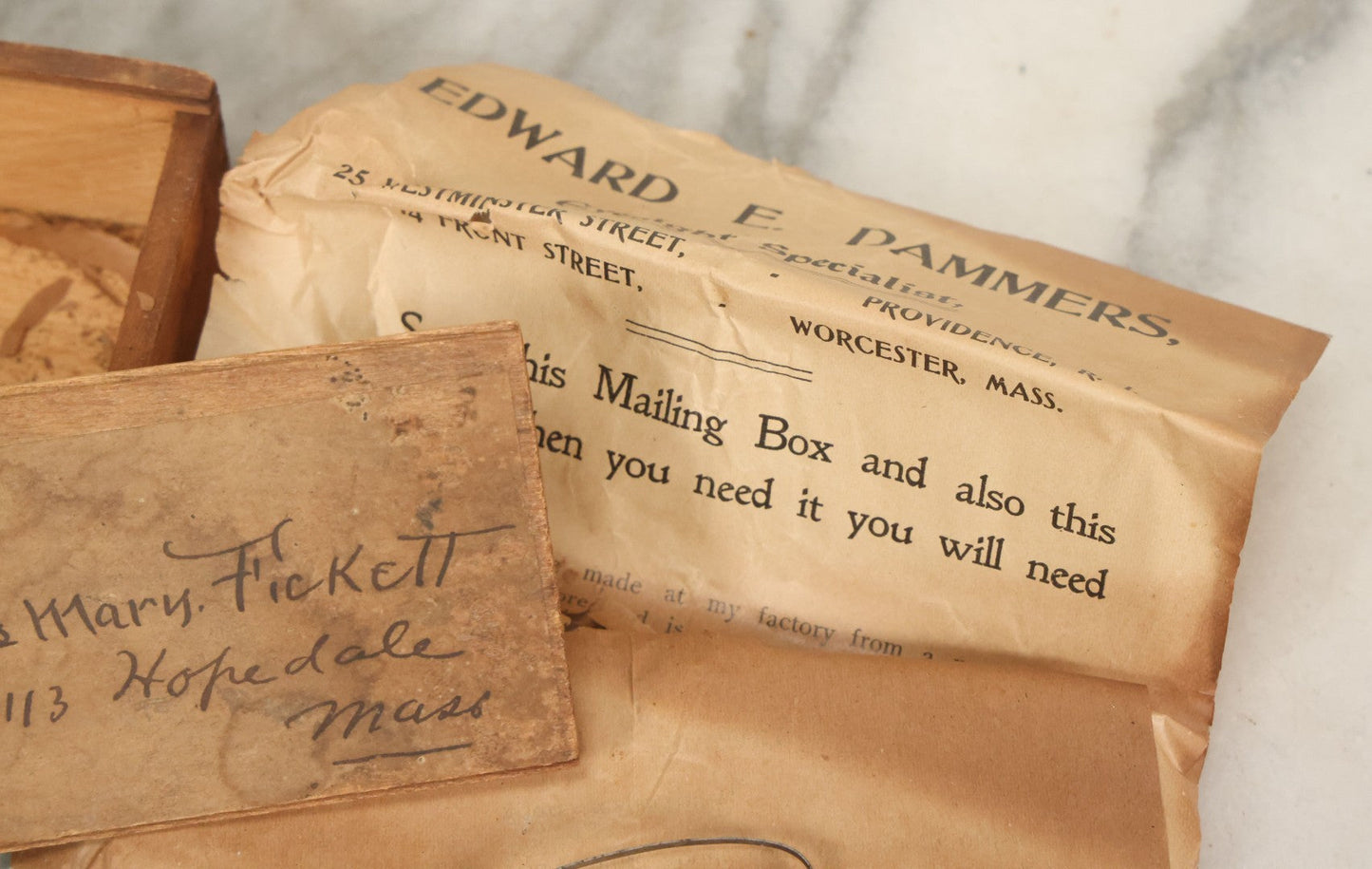 Lot 079 - Antique Slide Top Wooden Mailing Box From Edward E Dammers, Optician, Worcester, Massachusetts, Containing Two Pairs Of Antique Eyeglasses And Advertising Ephemera, Addressed To Mary Fickett, As Found, Note Cracks And Wear