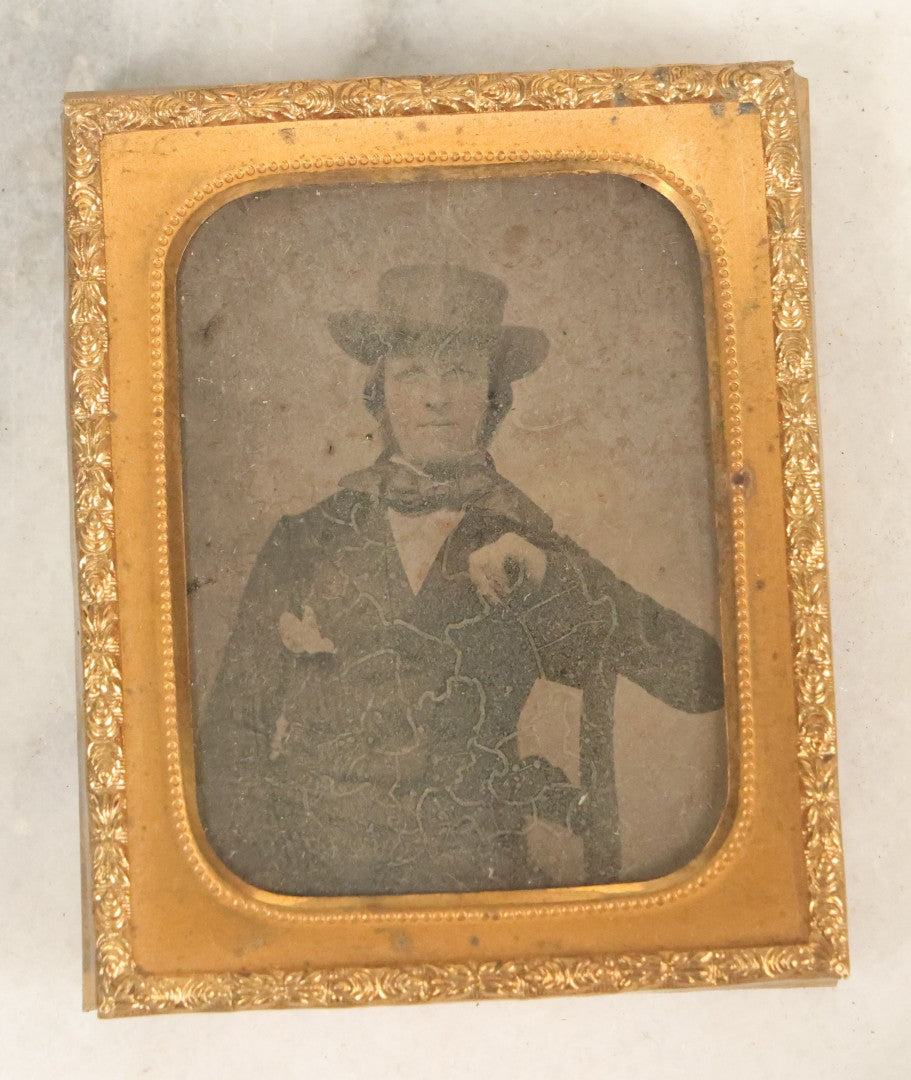 Lot 103 - Antique 1/9th Plate Ambrotype Photograph Of Young Man In Hat And Bowtie, Identified On Verso, Illegible, Note Heavy Wear, Uncased