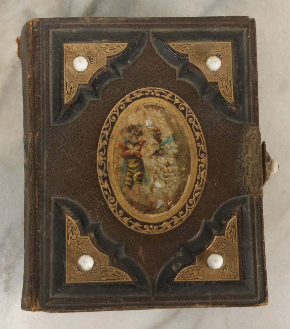 Lot 123 - Antique Cabinet Card And Tintype Family Photo Album, 3 C.D.V. Photos, 10 Tintypes, 2 Illustrated Album Filler Cards, Including Tintype Of Scowling Old Man And Illustrated Card Of Civil War Commander Foot, Cover With Harlequin And Fairy Motif