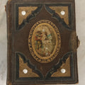 Lot 123 - Antique Cabinet Card And Tintype Family Photo Album, 3 C.D.V. Photos, 10 Tintypes, 2 Illustrated Album Filler Cards, Including Tintype Of Scowling Old Man And Illustrated Card Of Civil War Commander Foot, Cover With Harlequin And Fairy Motif