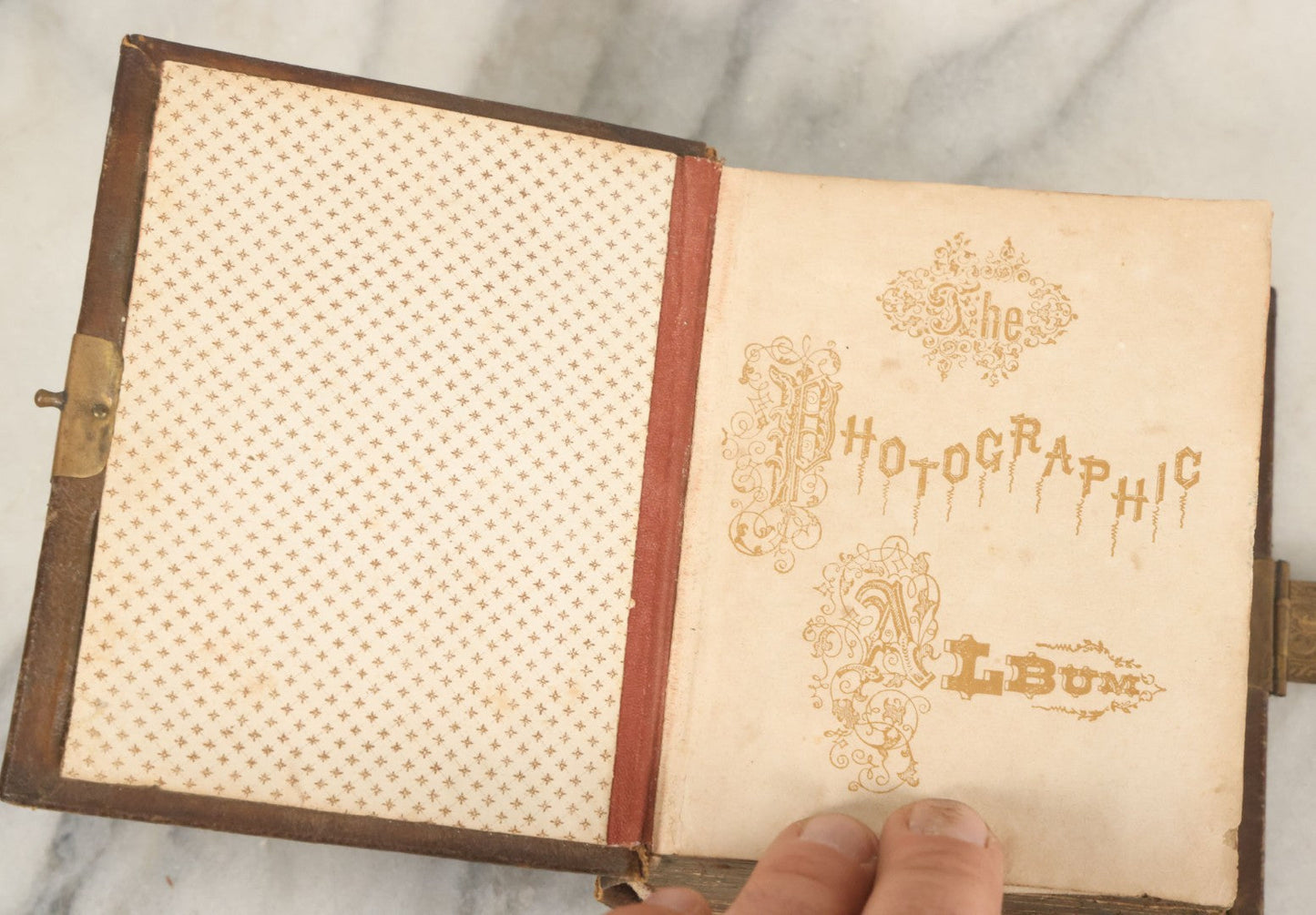 Lot 123 - Antique Cabinet Card And Tintype Family Photo Album, 3 C.D.V. Photos, 10 Tintypes, 2 Illustrated Album Filler Cards, Including Tintype Of Scowling Old Man And Illustrated Card Of Civil War Commander Foot, Cover With Harlequin And Fairy Motif