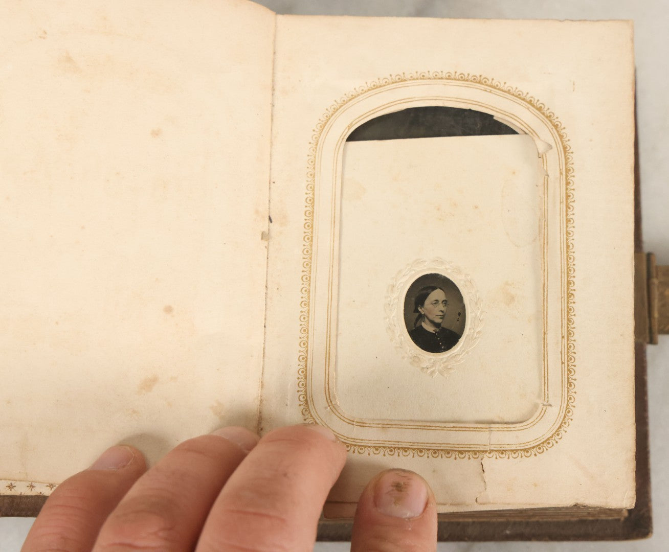 Lot 123 - Antique Cabinet Card And Tintype Family Photo Album, 3 C.D.V. Photos, 10 Tintypes, 2 Illustrated Album Filler Cards, Including Tintype Of Scowling Old Man And Illustrated Card Of Civil War Commander Foot, Cover With Harlequin And Fairy Motif