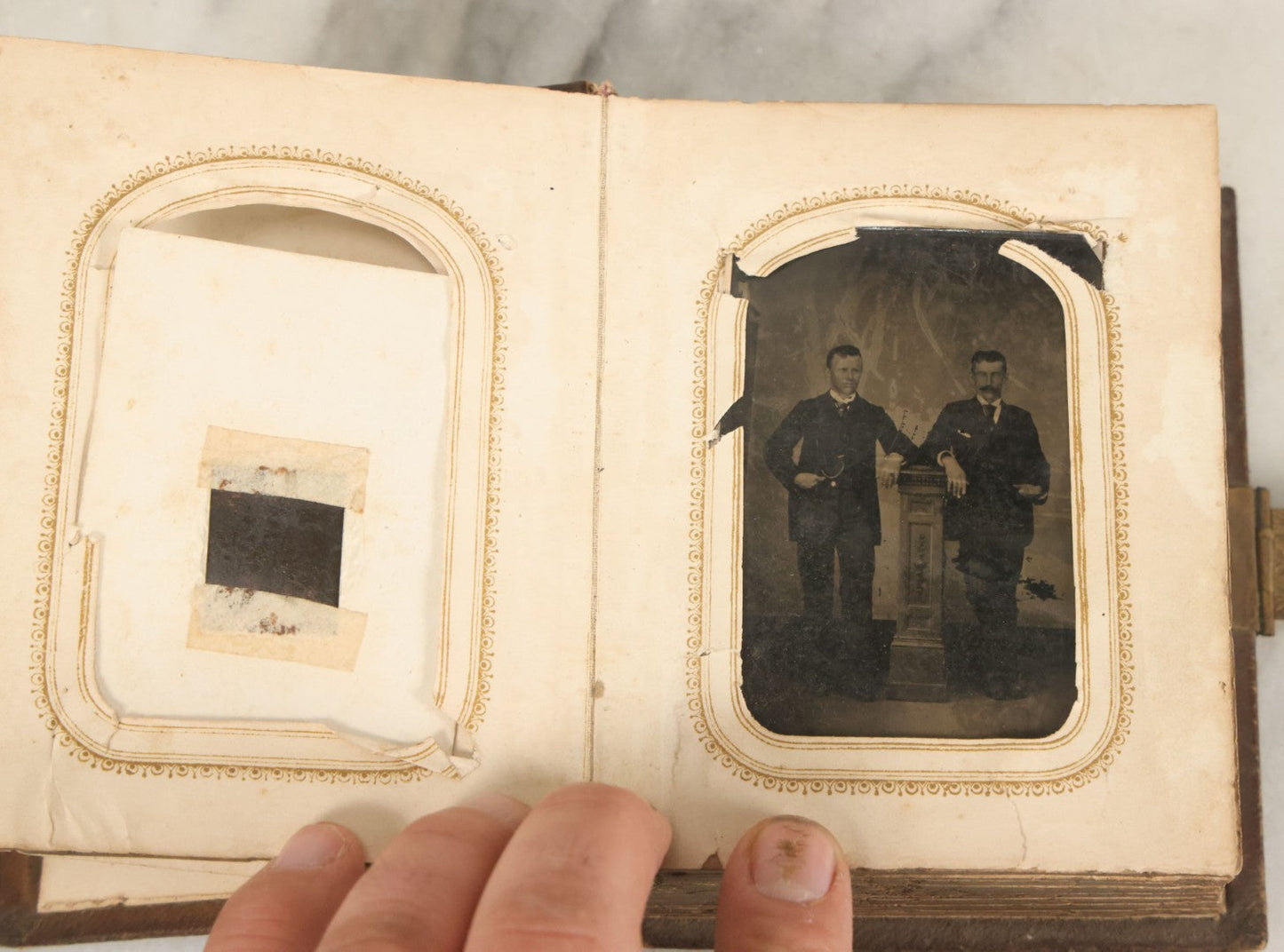 Lot 123 - Antique Cabinet Card And Tintype Family Photo Album, 3 C.D.V. Photos, 10 Tintypes, 2 Illustrated Album Filler Cards, Including Tintype Of Scowling Old Man And Illustrated Card Of Civil War Commander Foot, Cover With Harlequin And Fairy Motif