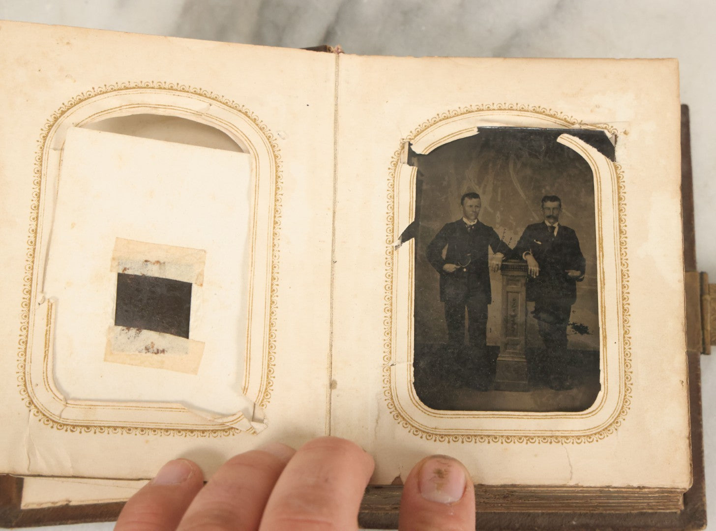 Lot 123 - Antique Cabinet Card And Tintype Family Photo Album, 3 C.D.V. Photos, 10 Tintypes, 2 Illustrated Album Filler Cards, Including Tintype Of Scowling Old Man And Illustrated Card Of Civil War Commander Foot, Cover With Harlequin And Fairy Motif