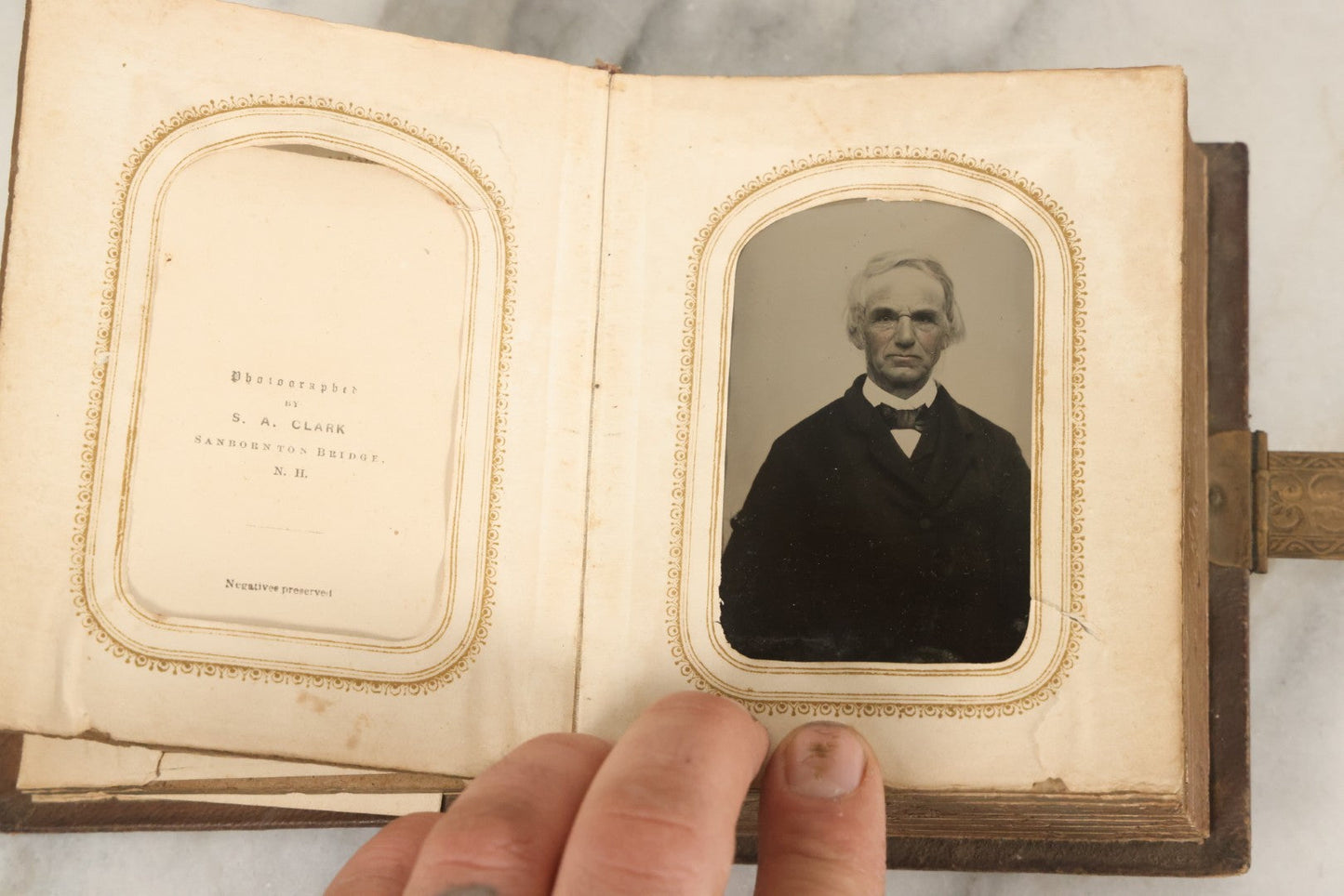 Lot 123 - Antique Cabinet Card And Tintype Family Photo Album, 3 C.D.V. Photos, 10 Tintypes, 2 Illustrated Album Filler Cards, Including Tintype Of Scowling Old Man And Illustrated Card Of Civil War Commander Foot, Cover With Harlequin And Fairy Motif