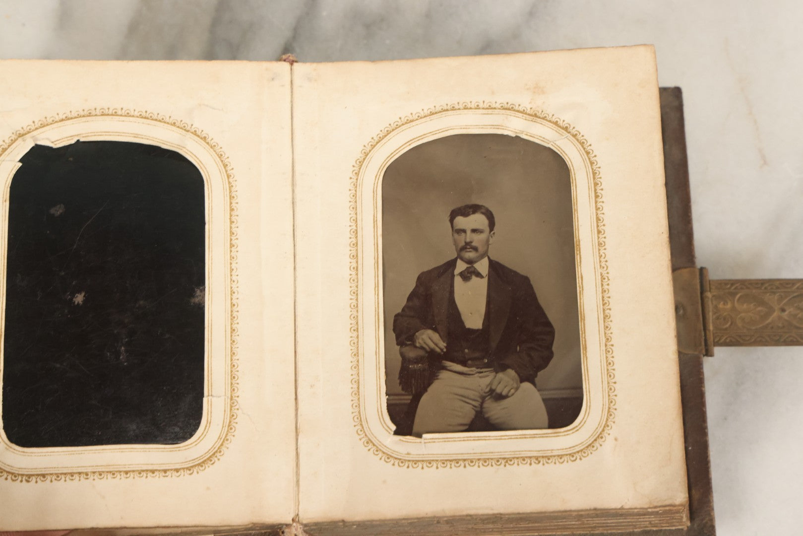 Lot 123 - Antique Cabinet Card And Tintype Family Photo Album, 3 C.D.V. Photos, 10 Tintypes, 2 Illustrated Album Filler Cards, Including Tintype Of Scowling Old Man And Illustrated Card Of Civil War Commander Foot, Cover With Harlequin And Fairy Motif