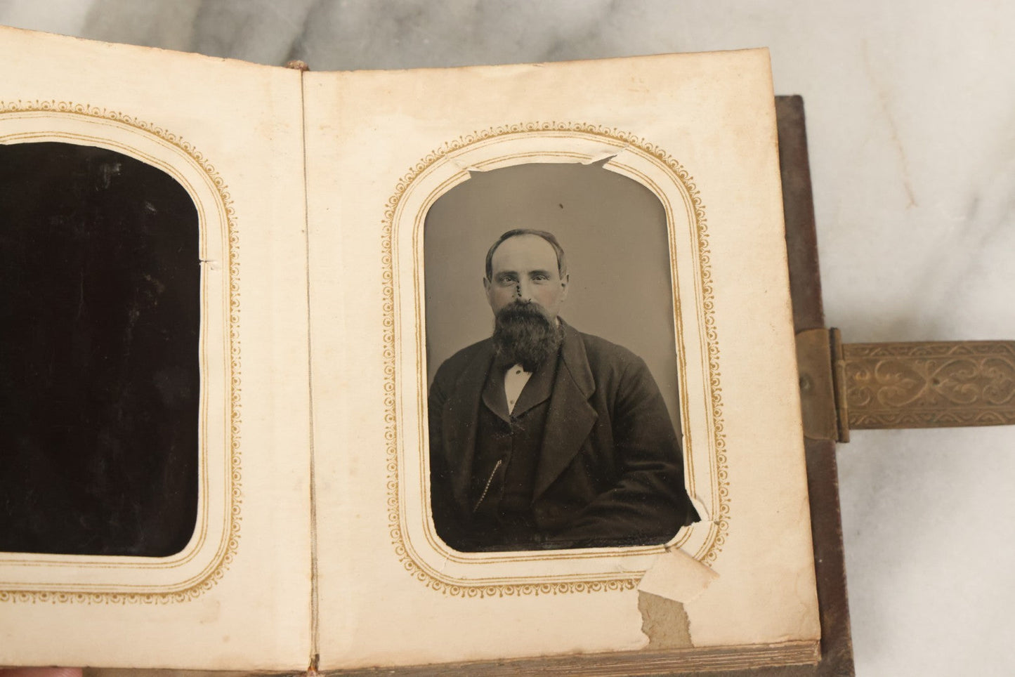 Lot 123 - Antique Cabinet Card And Tintype Family Photo Album, 3 C.D.V. Photos, 10 Tintypes, 2 Illustrated Album Filler Cards, Including Tintype Of Scowling Old Man And Illustrated Card Of Civil War Commander Foot, Cover With Harlequin And Fairy Motif