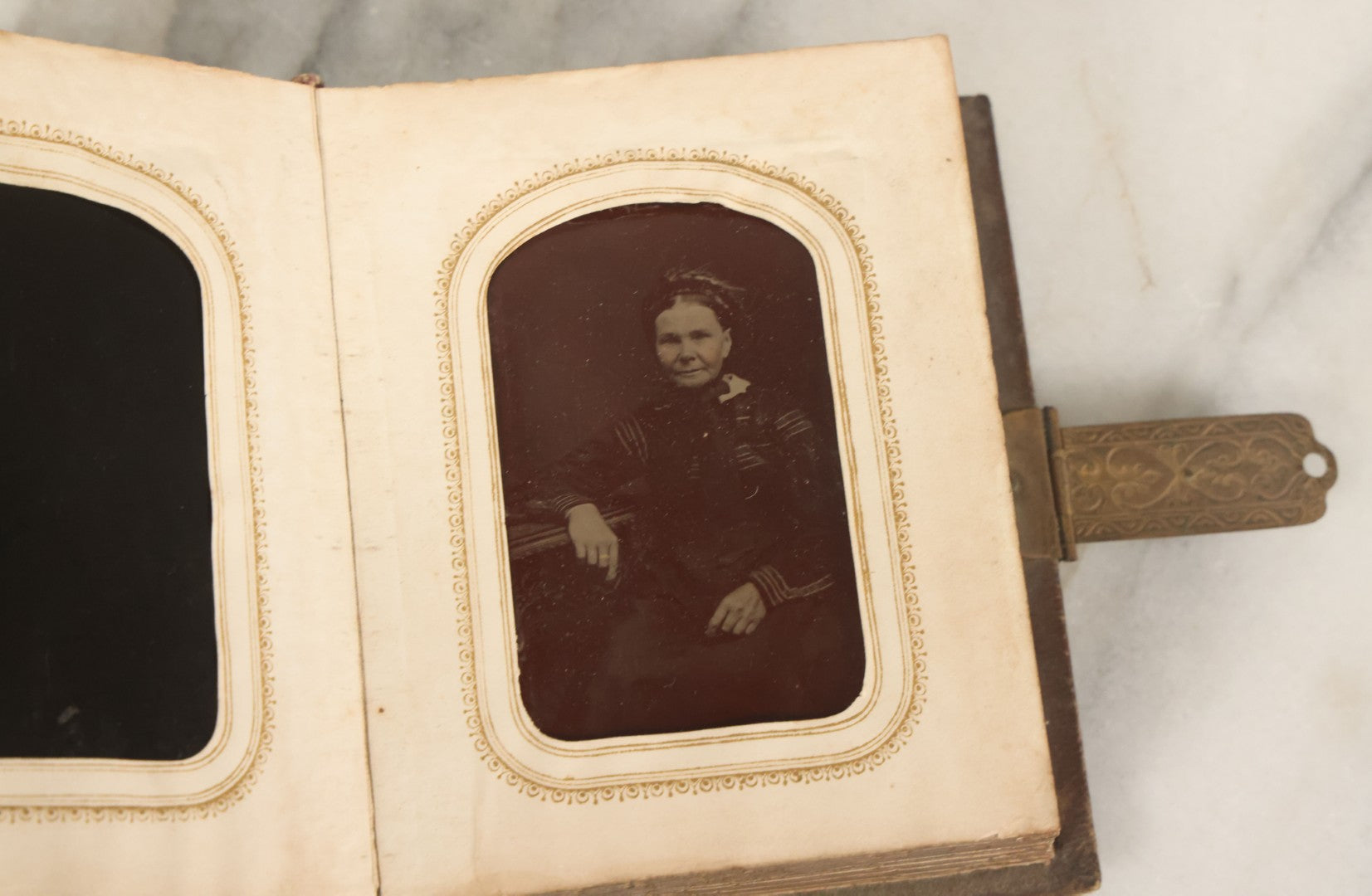 Lot 123 - Antique Cabinet Card And Tintype Family Photo Album, 3 C.D.V. Photos, 10 Tintypes, 2 Illustrated Album Filler Cards, Including Tintype Of Scowling Old Man And Illustrated Card Of Civil War Commander Foot, Cover With Harlequin And Fairy Motif